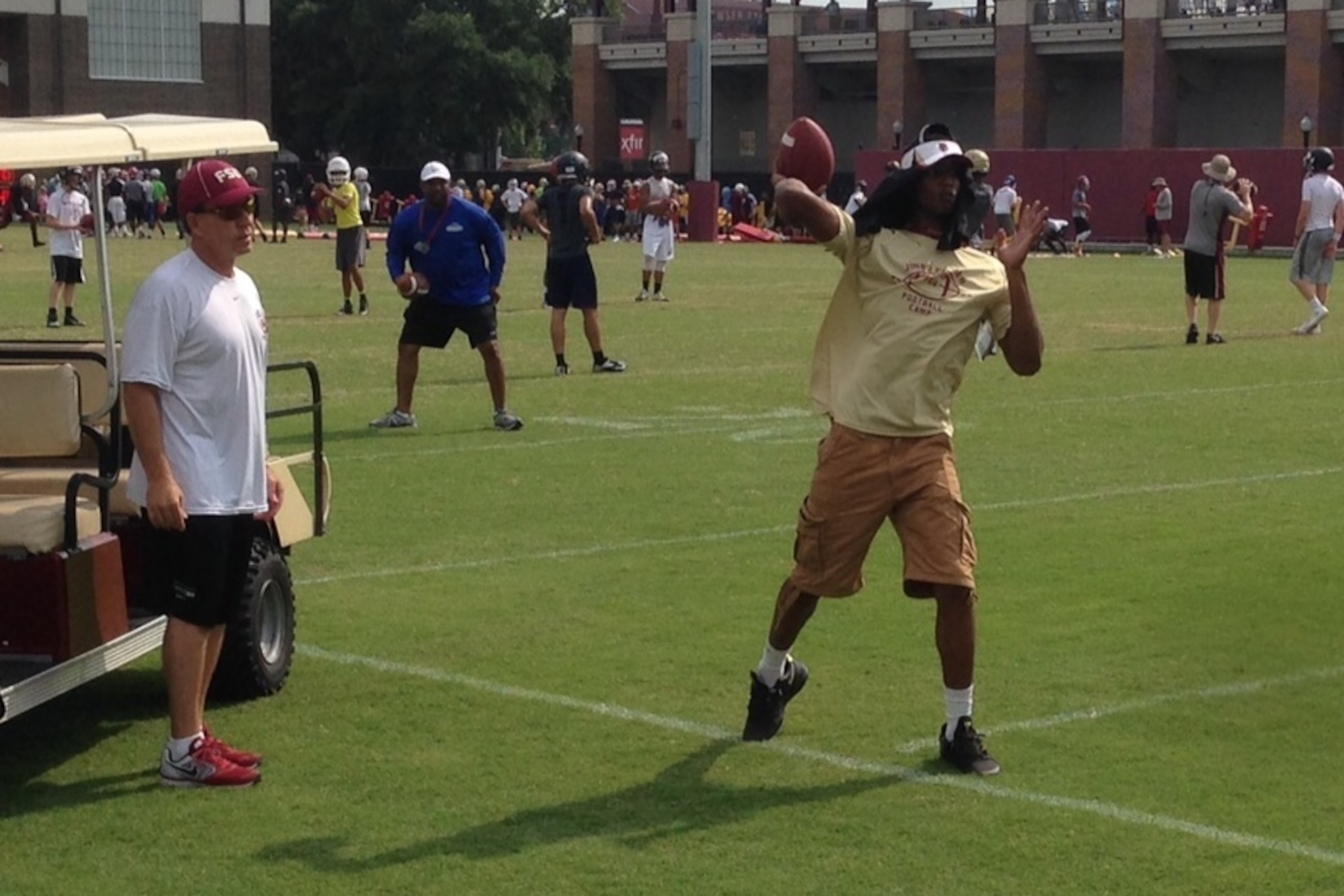 FSU coach Jimbo Fisher gives a few passing tips to 247Sports 4-star quarterback Kai Locksley.