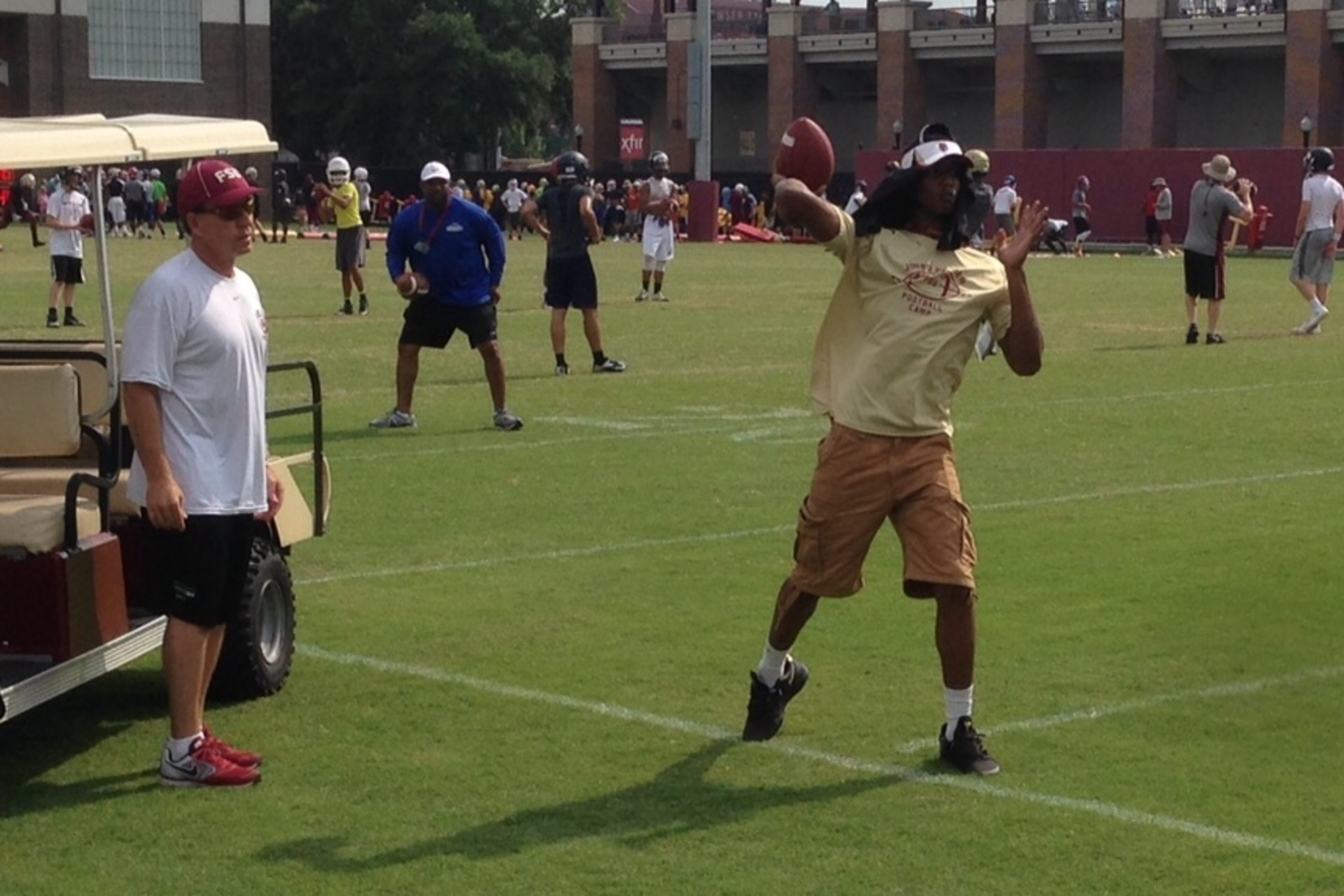 FSU coach Jimbo Fisher gives a few passing tips to 247Sports 4-star quarterback Kai Locksley.