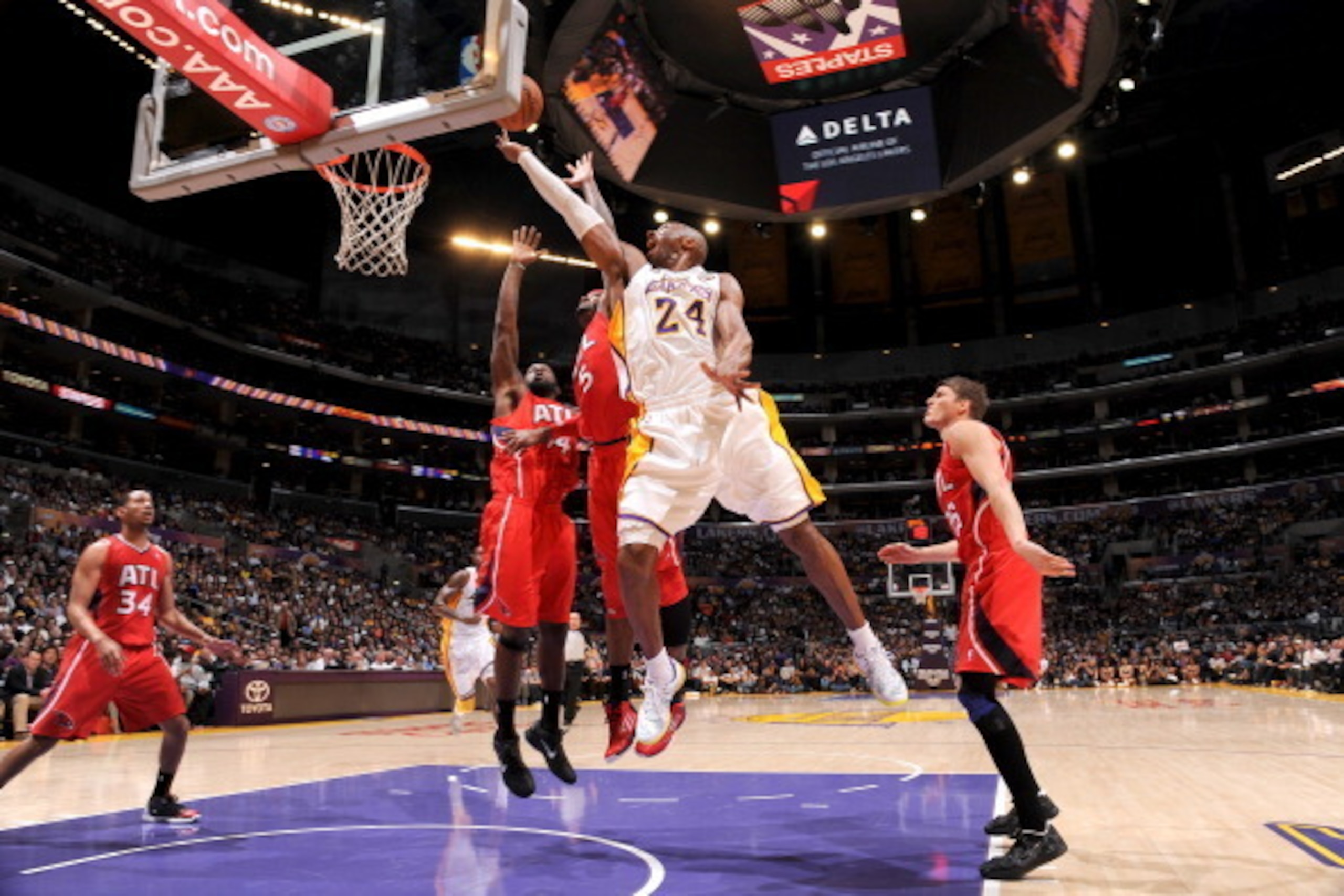 LOS ANGELES, CA - MARCH 3: Kobe Bryant #24 of the Los Angeles Lakers shoots a layup against Josh Smith #5 of the Atlanta Hawks at Staples Center on March 3, 2013 in Los Angeles, California. NOTE TO USER: User expressly acknowledges and agrees that, by dow