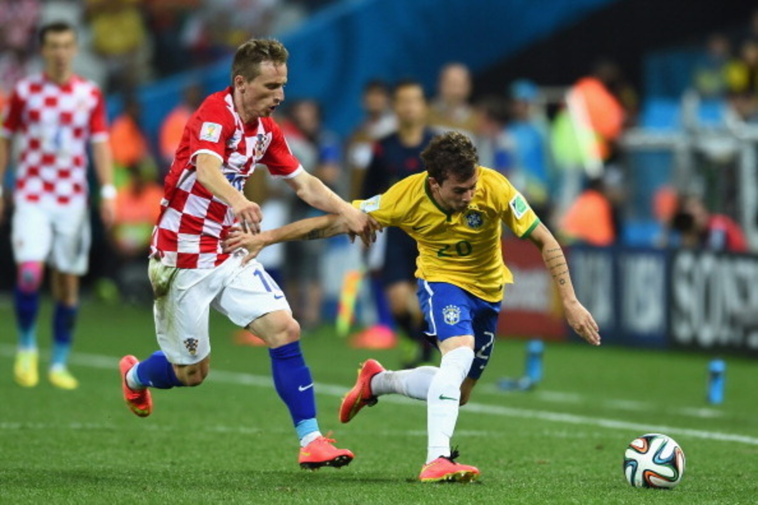 SAO PAULO, BRAZIL - JUNE 12:  Luka Modric of Croatia closes down Bernard of Brazil during the 2014 FIFA World Cup Brazil Group A match between Brazil and Croatia at Arena de Sao Paulo on June 12, 2014 in Sao Paulo, Brazil.  (Photo by Buda Mendes/Getty Ima