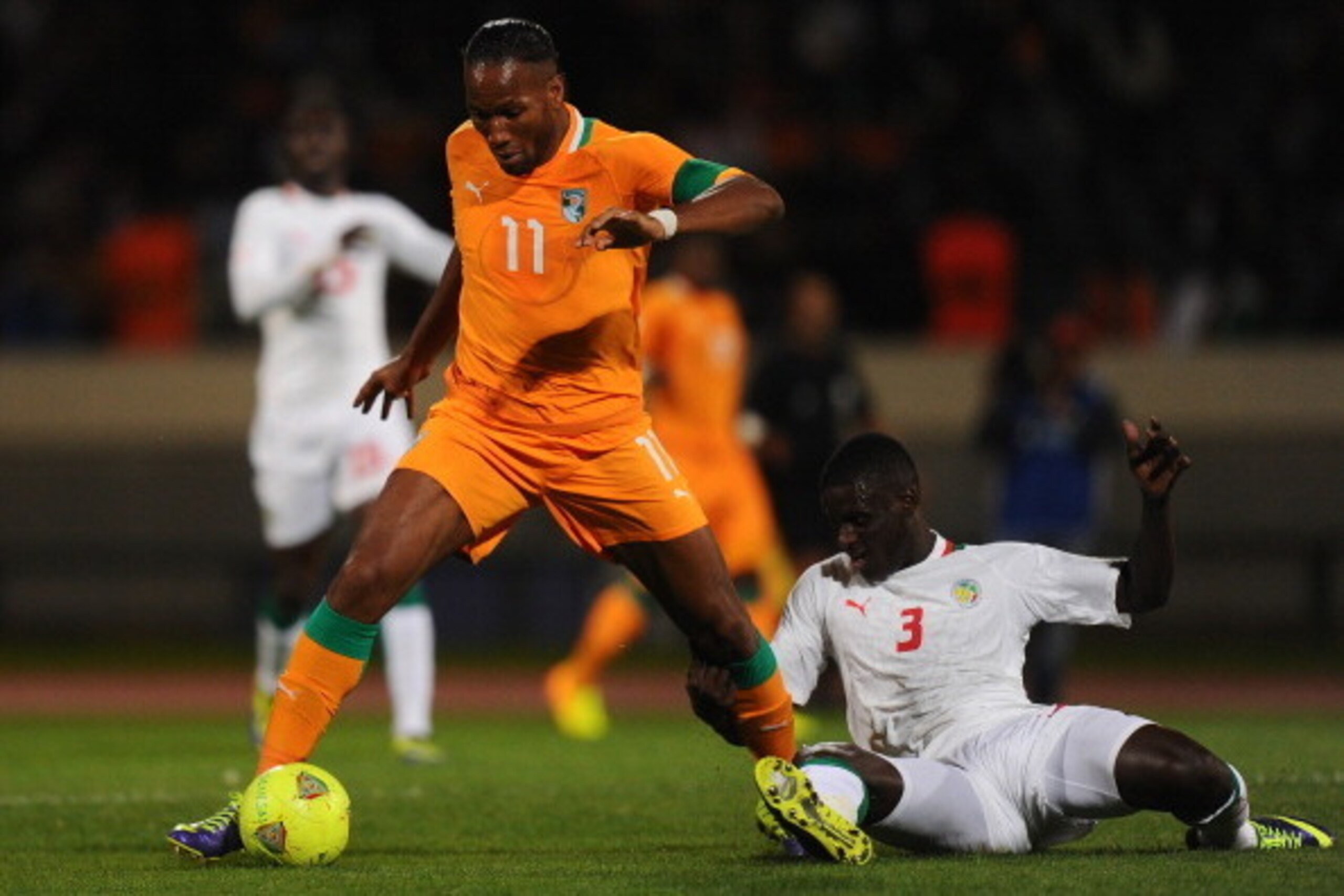 CASABLANCA, MOROCCO - NOVEMBER 16:  Didier Drogba of Ivory Coast battles with Kara Mbodji of Senegal during the FIFA 2014 World Cup Qualifier Play-off Second Leg between Senegal and Ivory Coast at Stade Mohammed V on November 16, 2013 in Casablanca, Moroc