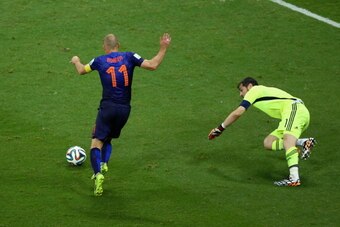 SALVADOR, BRAZIL - JUNE 13:  Arjen Robben of the Netherlands shoots and scores his second goal, the teams fifth, as goalkeeper Iker Casillas of Spain looks on during the 2014 FIFA World Cup Brazil Group B match between Spain and Netherlands at Arena Fonte