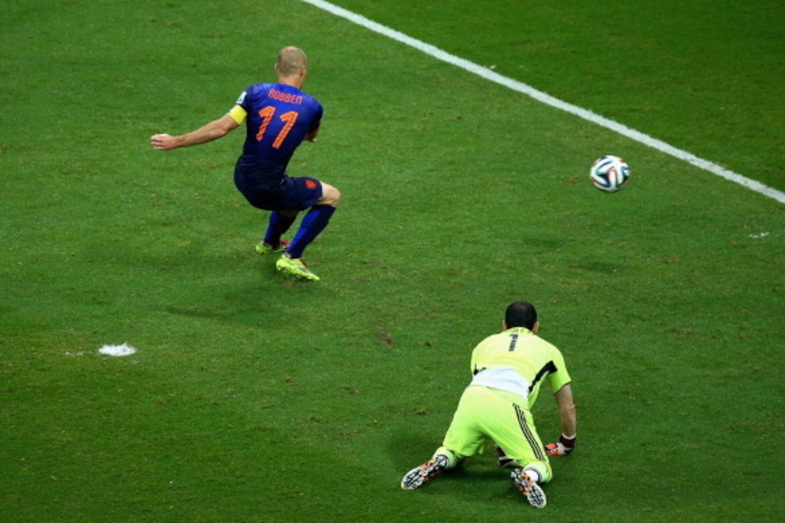 SALVADOR, BRAZIL - JUNE 13:  Arjen Robben of the Netherlands shoots and scores his second goal, the teams fifth, as goalkeeper Iker Casillas of Spain looks on during the 2014 FIFA World Cup Brazil Group B match between Spain and Netherlands at Arena Fonte