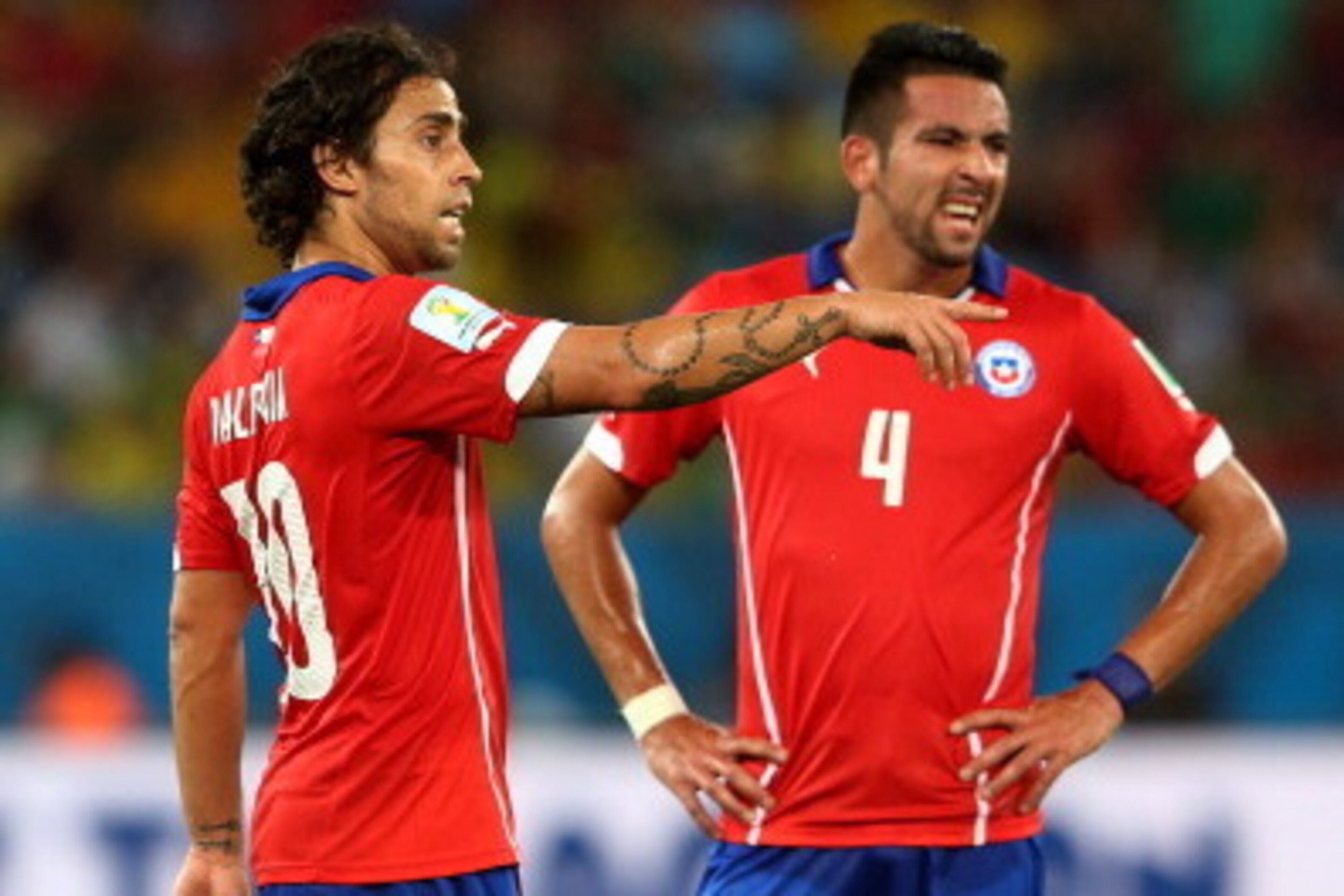 CUIABA, BRAZIL - JUNE 13: Jorge Valdivia (L) and Mauricio Isla of Chile discuss a free kick during the 2014 FIFA World Cup Brazil Group B match between Chile and Australia at Arena Pantanal on June 13, 2014 in Cuiaba, Brazil.  (Photo by Cameron Spencer/Ge