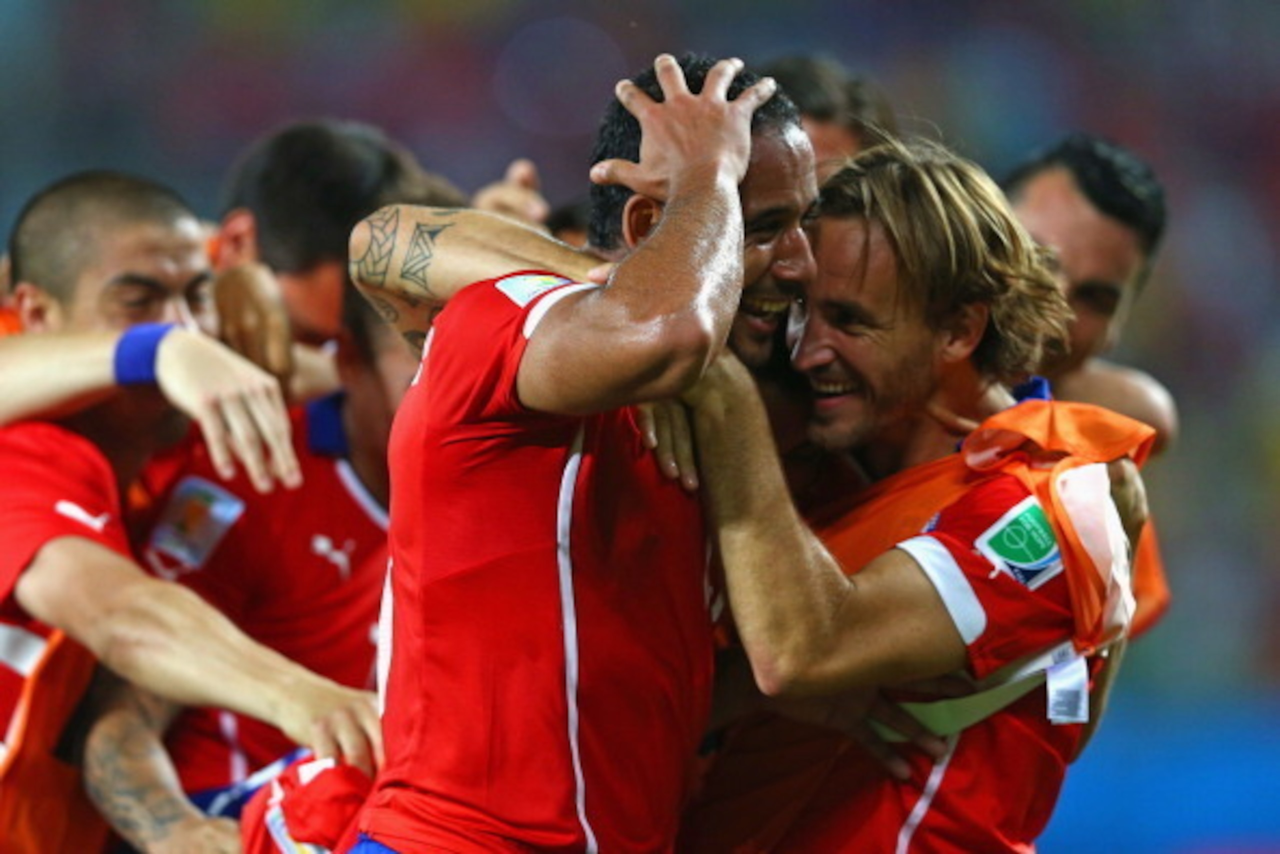CUIABA, BRAZIL - JUNE 13:  Jean Beausejour of Chile (L) celebrates scoring his teams third goal with teammates during the 2014 FIFA World Cup Brazil Group B match between Chile and Australia at Arena Pantanal on June 13, 2014 in Cuiaba, Brazil.  (Photo by