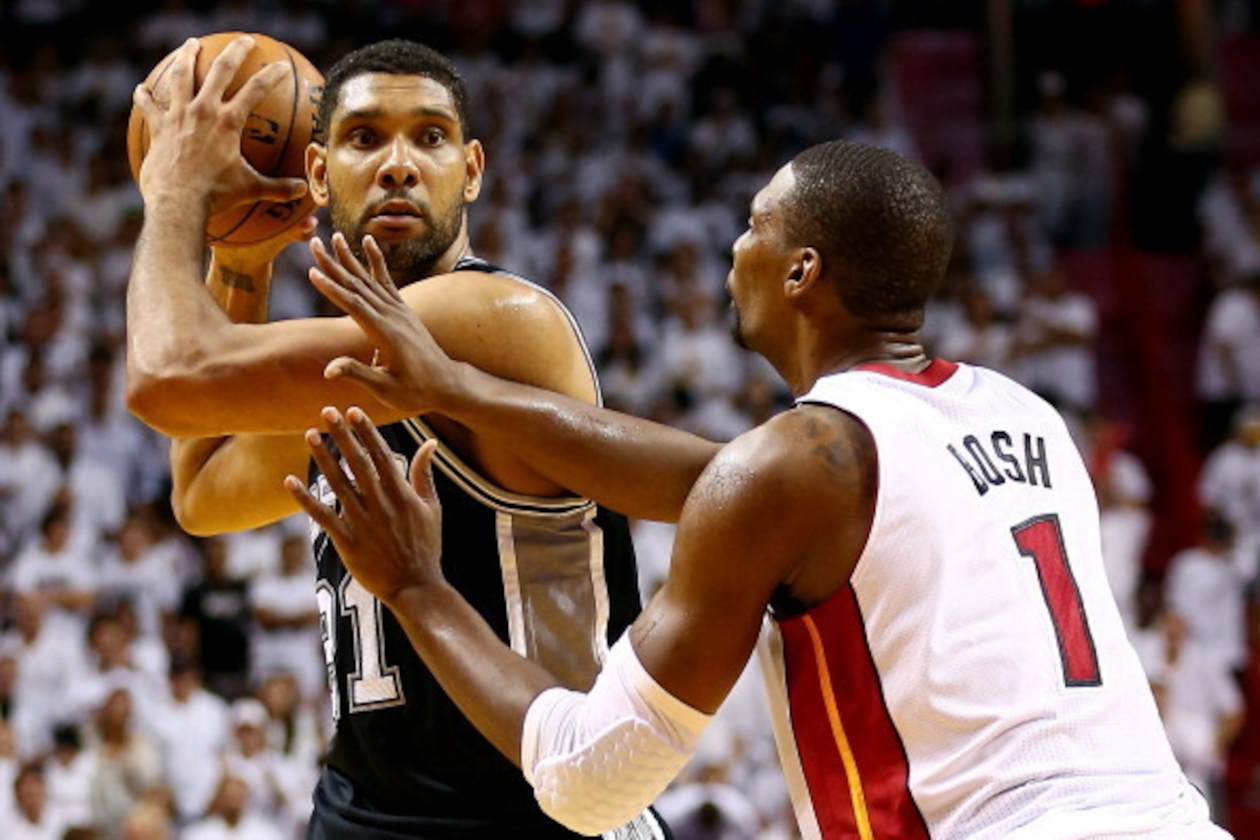 MIAMI, FL - JUNE 12: Tim Duncan #21 of the San Antonio Spurs looks to pass as Chris Bosh #1 of the Miami Heat defends during Game Four of the 2014 NBA Finals at American Airlines Arena on June 12, 2014 in Miami, Florida. NOTE TO USER: User expressly ackno