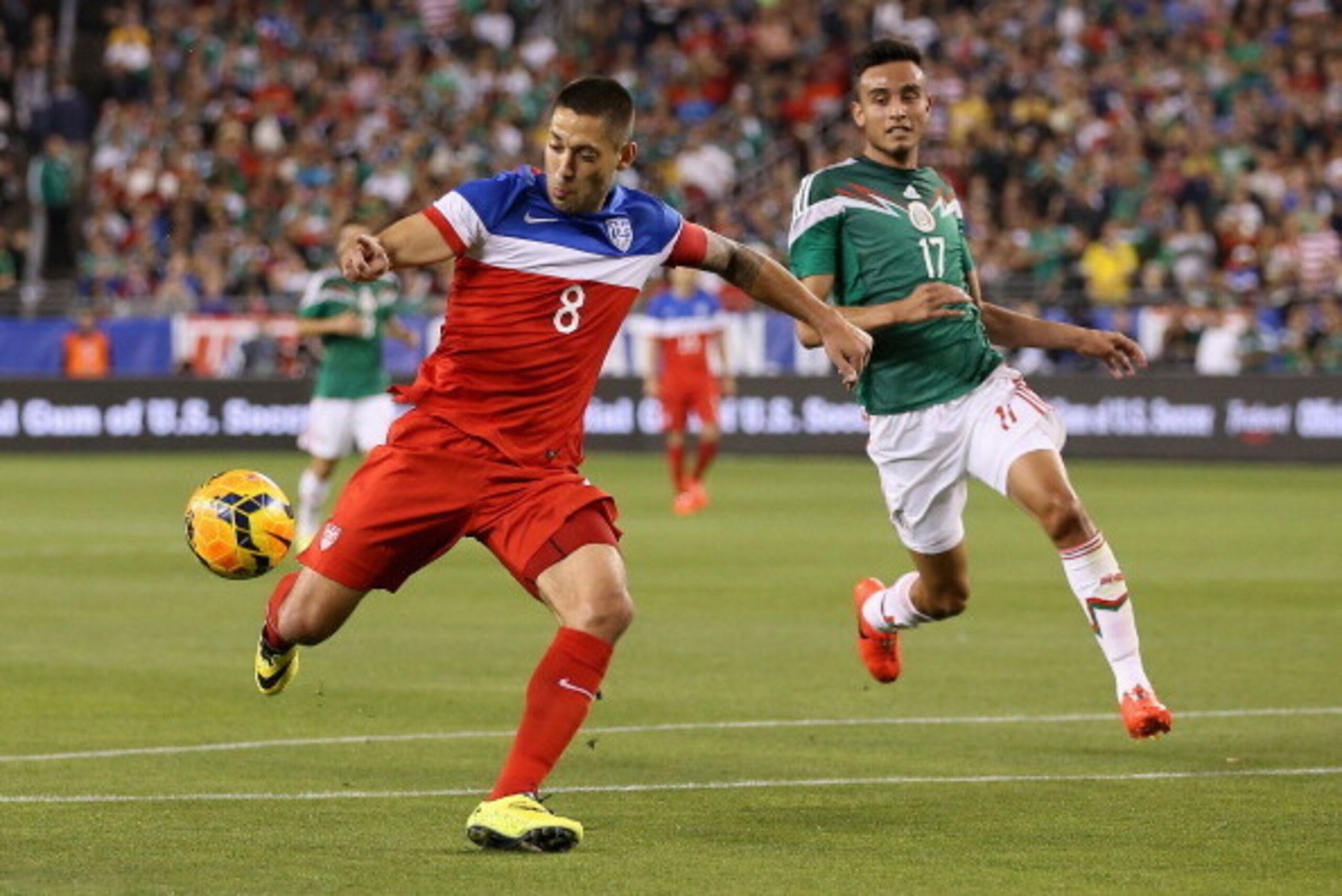 GLENDALE, AZ - APRIL 02:  Clint Dempsey #8 of USA shoots the ball past Jesus Eduardo Zavala #17 of Mexico during the first half of the International Friendly at University of Phoenix Stadium on April 2, 2014 in Glendale, Arizona.  Mexico and USA played to