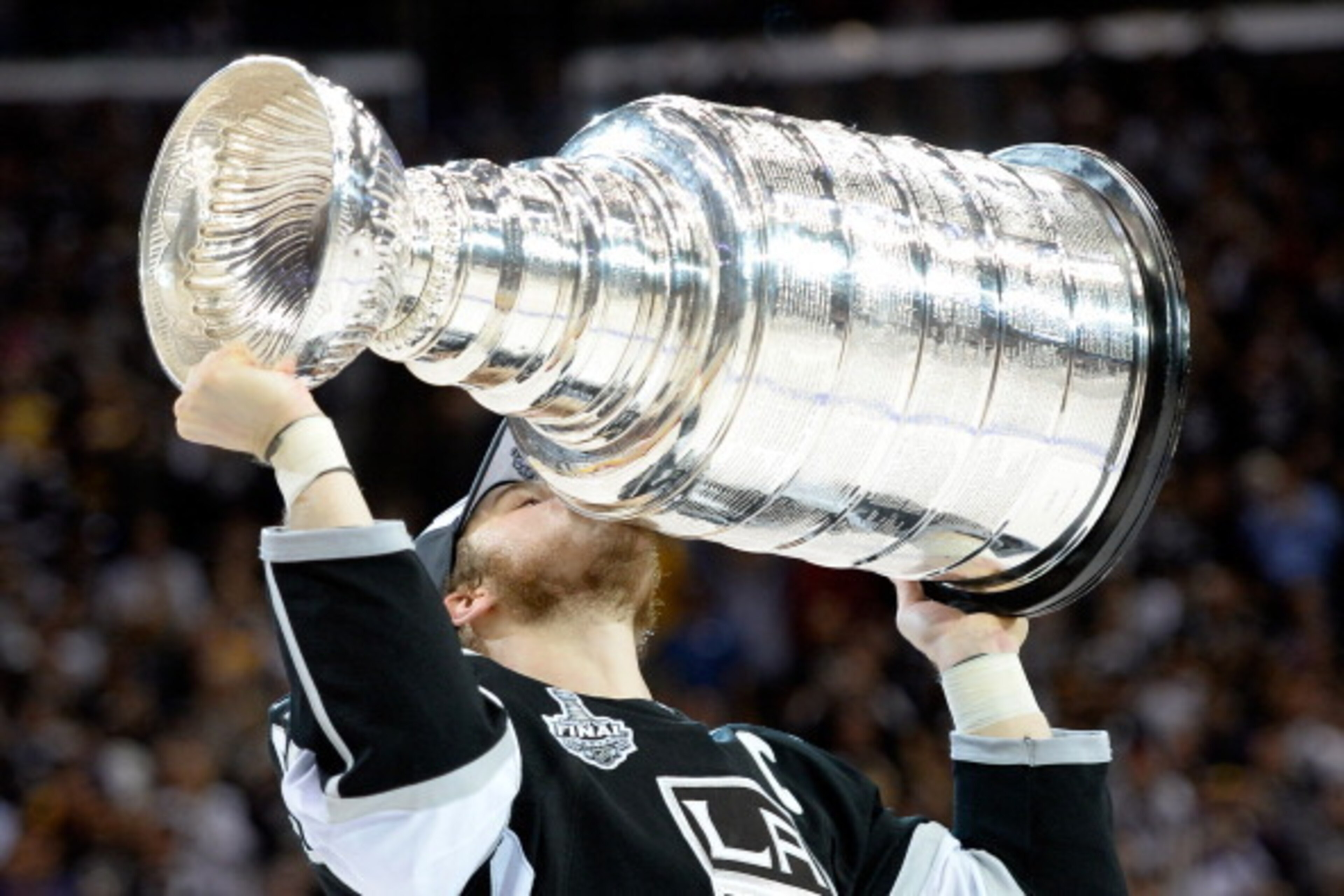 LOS ANGELES, CA - JUNE 13:  Dustin Brown #23 of the Los Angeles Kings celebrates with the Stanley Cup after the Kings 3-2 double overtime victory against the New York Rangers in Game Five of the 2014 Stanley Cup Final at Staples Center on June 13, 2014 in