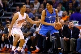 Apr 6, 2014; Phoenix, AZ, USA; Oklahoma City Thunder guard Jeremy Lamb (11) controls the ball against Phoenix Suns forward Gerald Green at US Airways Center. The Suns defeated the Thunder 122-115. Mandatory Credit: Mark J. Rebilas-USA TODAY Sports