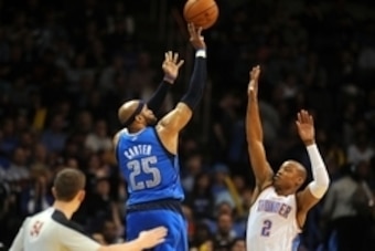 Mar 16, 2014; Oklahoma City, OK, USA; Dallas Mavericks guard Vince Carter (25) attempts a 3 point shot against Oklahoma City Thunder forward Caron Butler (2) during the fourth quarter at Chesapeake Energy Arena. Mandatory Credit: Mark D. Smith-USA TODAY S