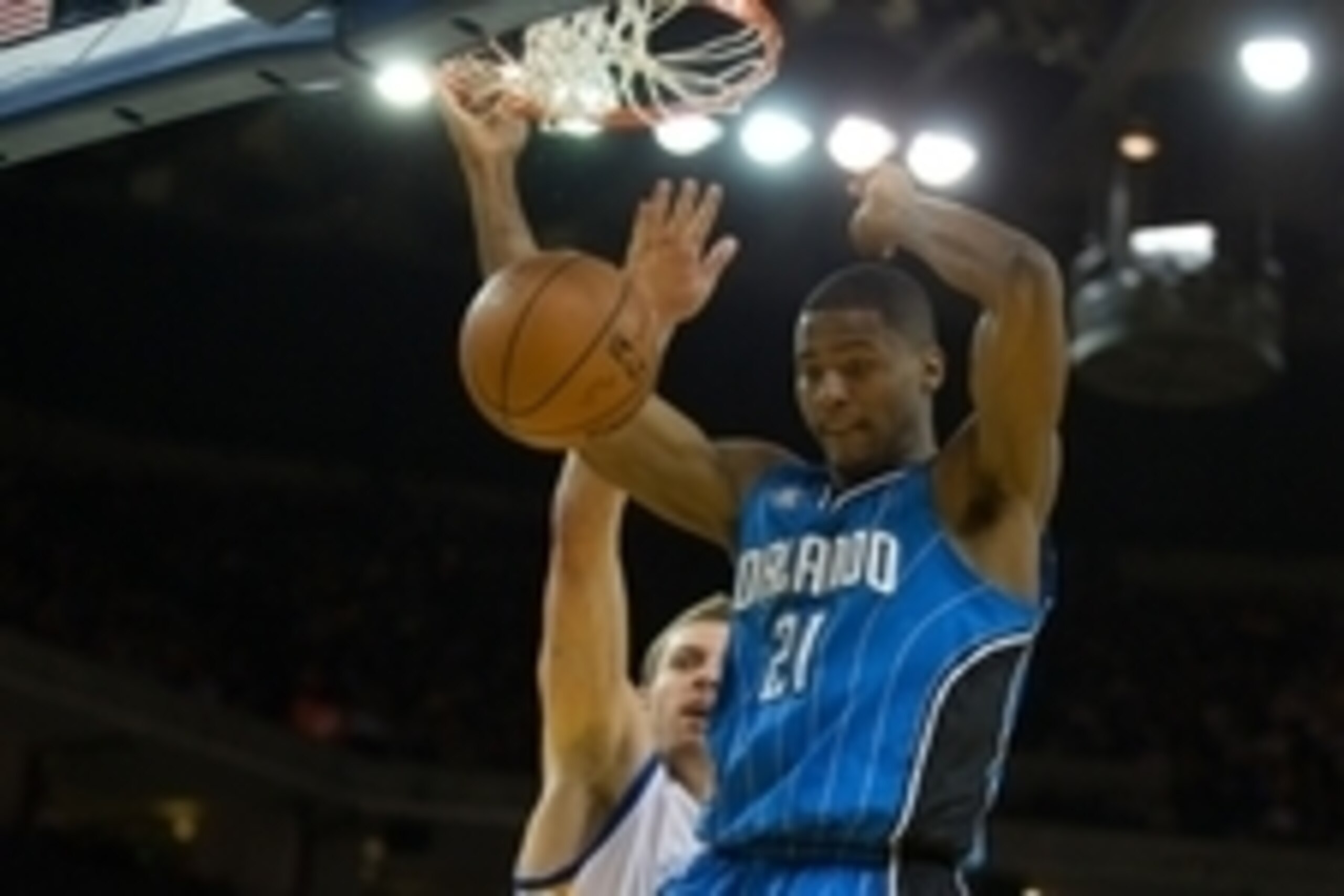 Mar 18, 2014; Oakland, CA, USA; Orlando Magic forward Maurice Harkless (21) dunks the ball against Golden State Warriors forward David Lee (10) during the second quarter at Oracle Arena. Mandatory Credit: Kelley L Cox-USA TODAY Sports