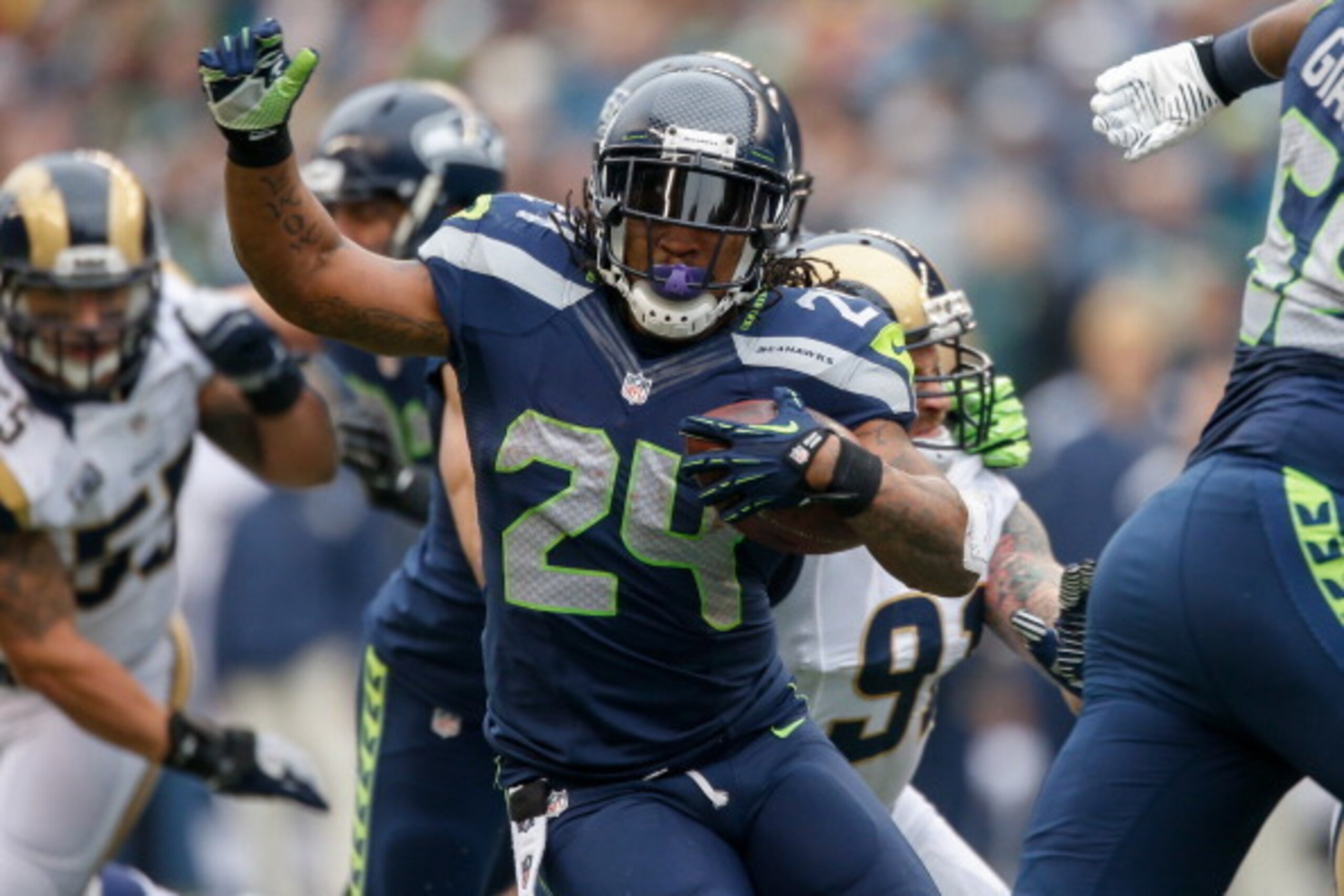 SEATTLE, WA - DECEMBER 29:  Running back Marshawn Lynch #24 of the Seattle Seahawks rushes against the St. Louis Rams at CenturyLink Field on December 29, 2013 in Seattle, Washington.  (Photo by Otto Greule Jr/Getty Images)