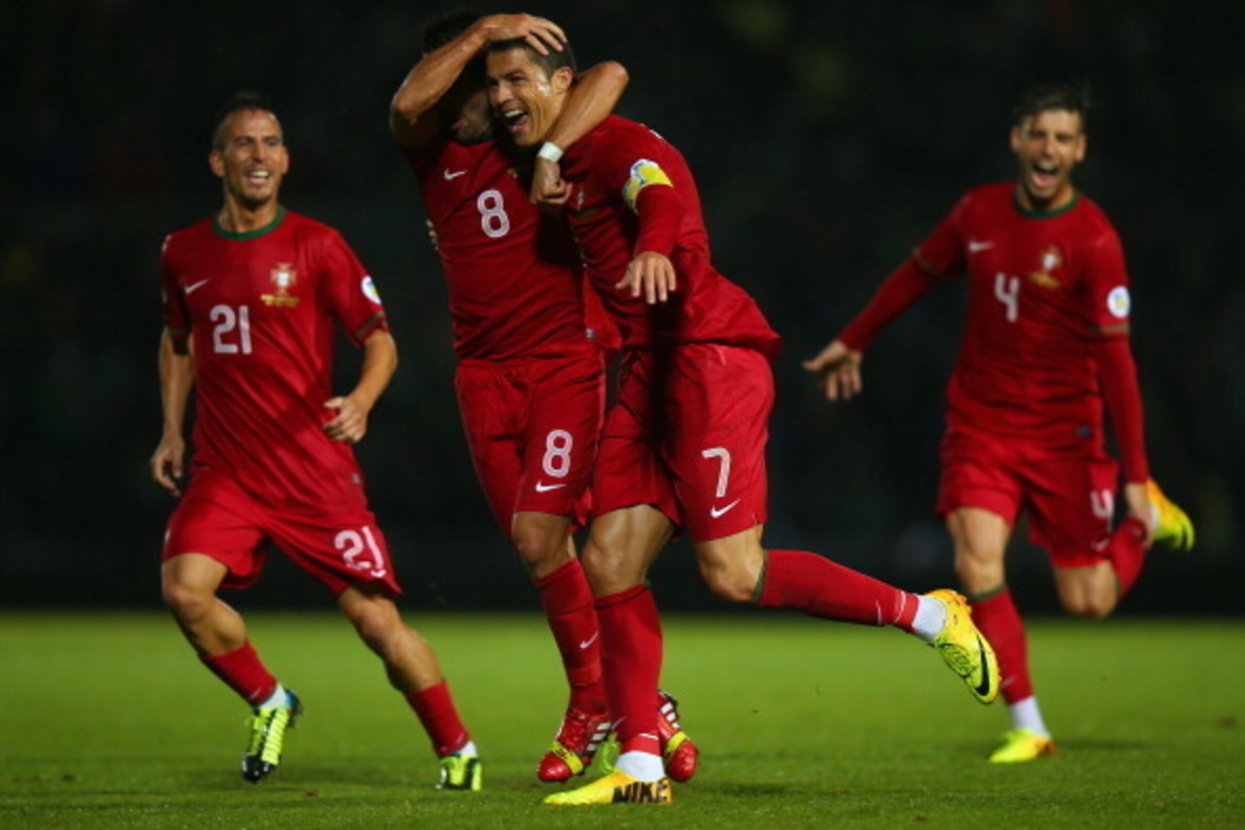 BELFAST, NORTHERN IRELAND - SEPTEMBER 06:  Cristiano Ronaldo of Portugal celebrates scoring with team mate Joao Periera during the FIFA 2014 World Cup Qualifying Group F match between Northern Ireland and Portugal at Windsor Park on September 6, 2013 in B