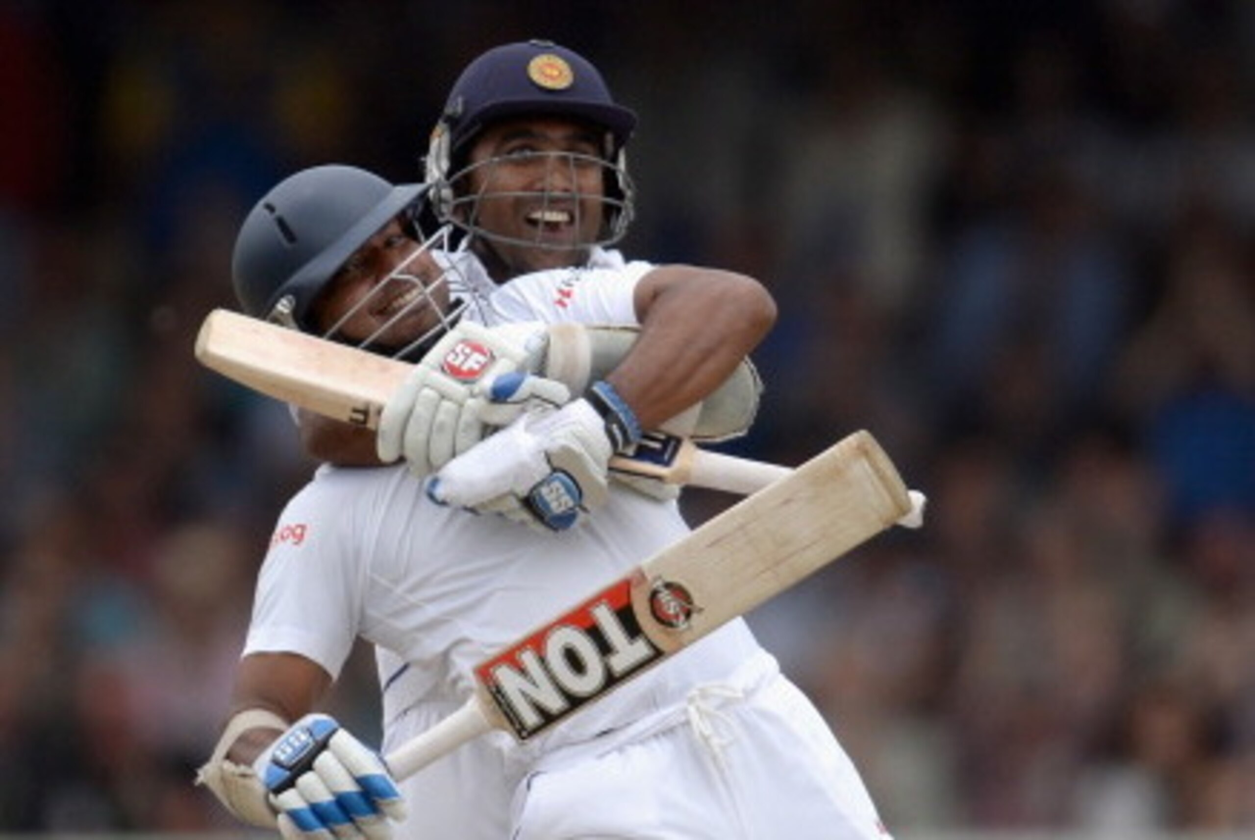 LONDON, ENGLAND - JUNE 14:  Kumar Sangakkara of Sri Lanka celebrates reaching his century with teammate Mahela Jayawardena during day three of 1st Investec Test match between England and Sri Lanka at Lord's Cricket Ground on June 14, 2014 in London, Engla