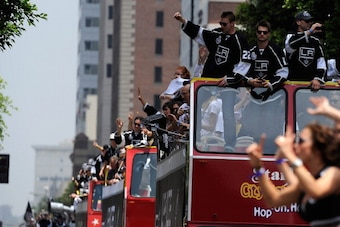 LOS ANGELES, CA - JUNE 14:  Los Angeles Kings team members from  left Trevor Lewis #22, Brad Richardson #15 and Jarret Stoll# 28 wave to cheering fans during the Stanley Cup victory parade on June 14, 2012 in Los Angeles, California. The Kings are celebra