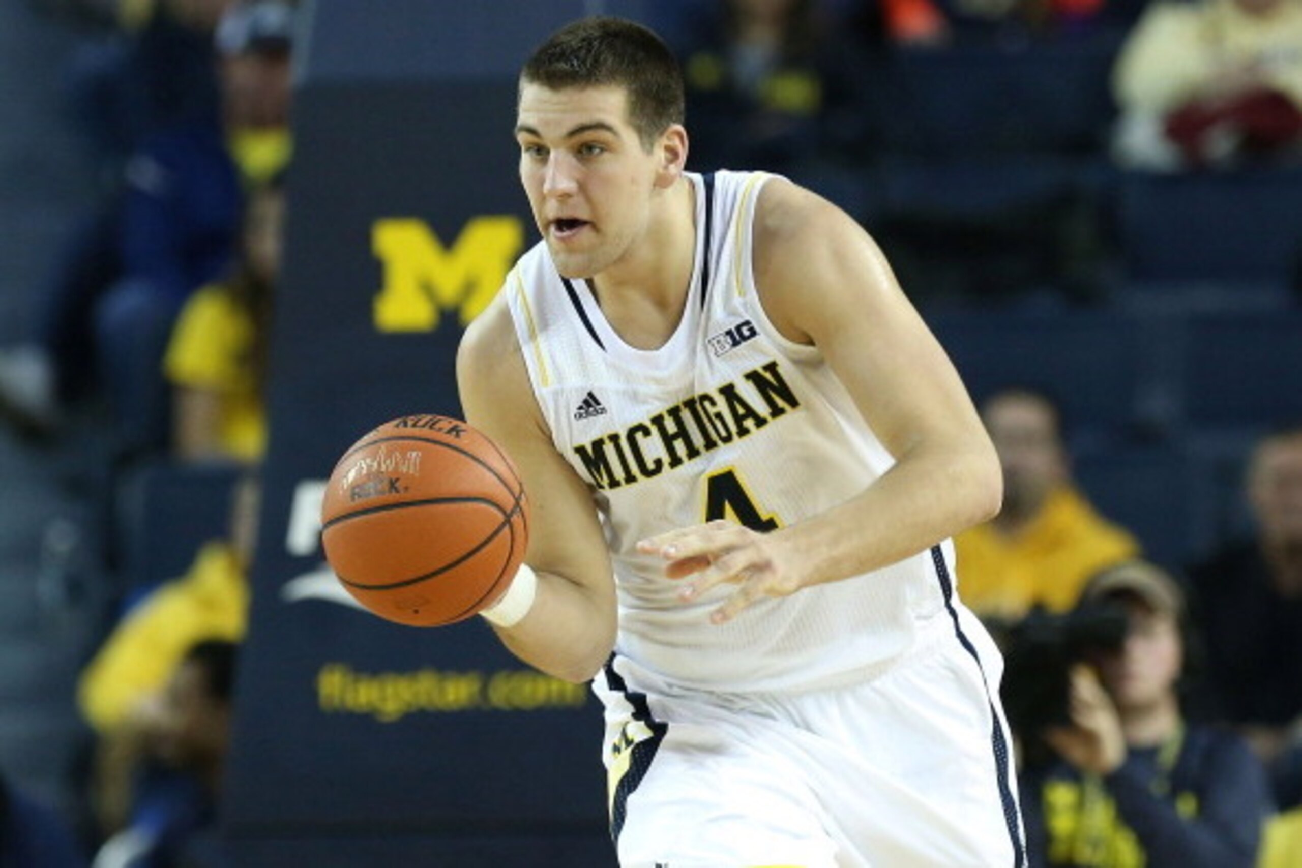 ANN ARBOR, MI - DECEMBER 07:  Mitch McGary #4 of the University of Michigan Wolverines drives the ball up the court during the second half of the game against Houston Baptist Huskies at the Crisler Center on December 7, 2013 in Ann Arbor, Michigan. Michig