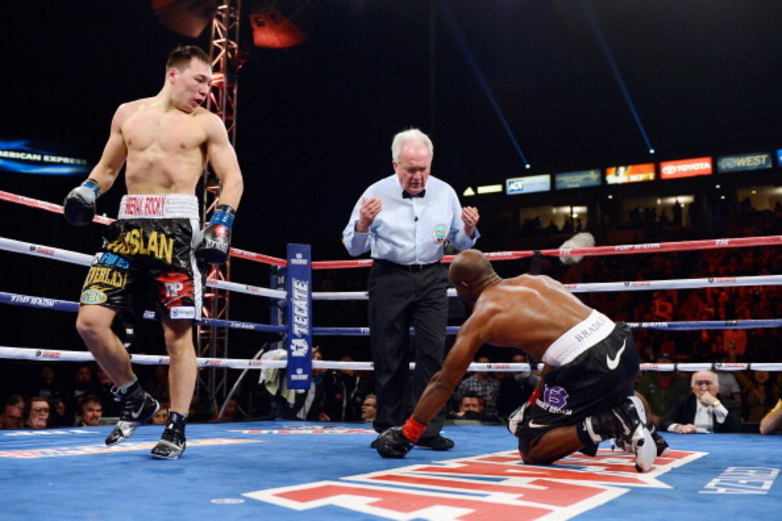 CARSON, CA - MARCH 16:  WBO Welterweight Champion Timothy Bradley (R) is knocked down in the first round by contender Ruslan Provodnikov as referee Pat Ruseell (C) looks on during their WBO Welterweight Championship boxing match at The Home Depot Center o