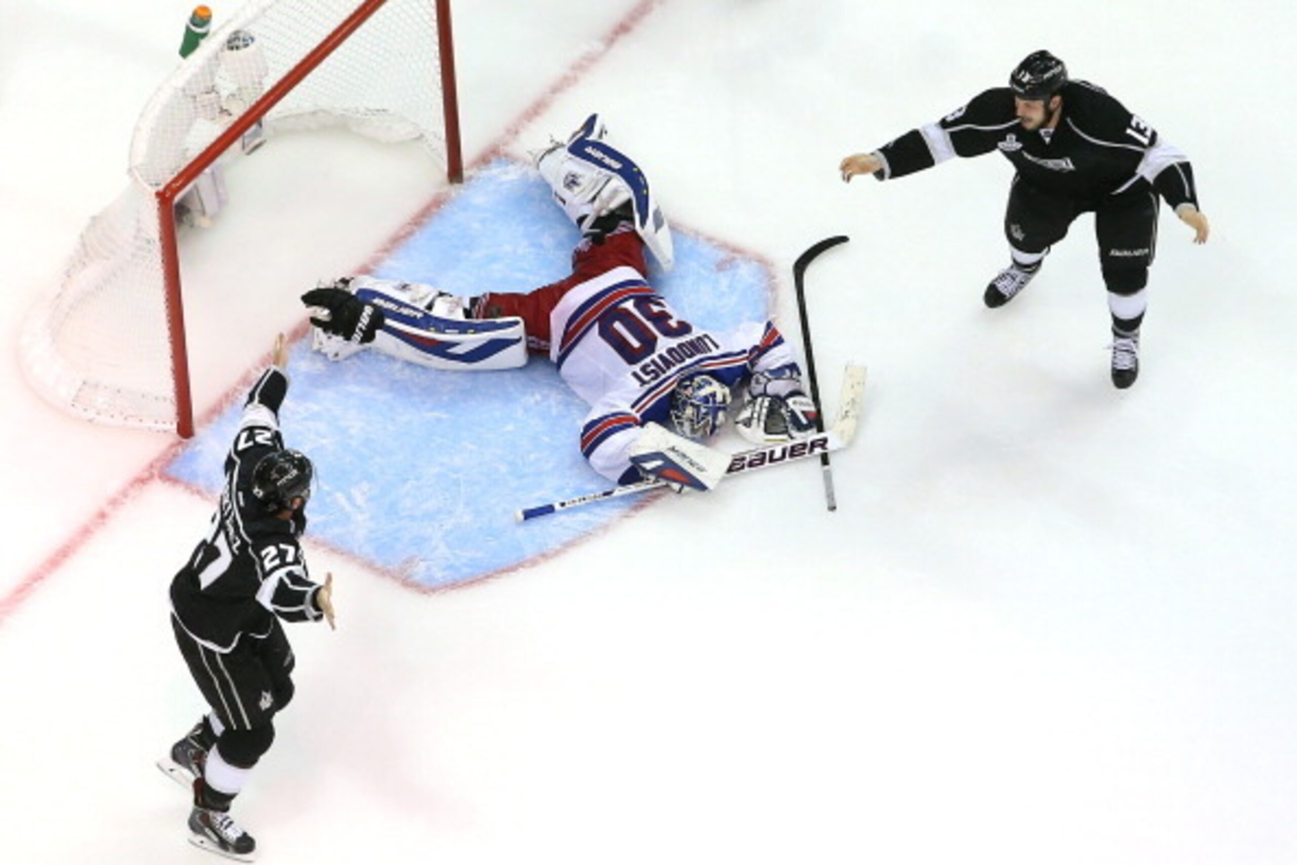 LOS ANGELES, CA - JUNE 13:  Alec Martinez #27 of the Los Angeles Kings celebrates with Kyle Clifford #13 after Martinez scores the game-winning goal in double overtime against goaltender Henrik Lundqvist #30 of the New York Rangers to give the Kings the 3
