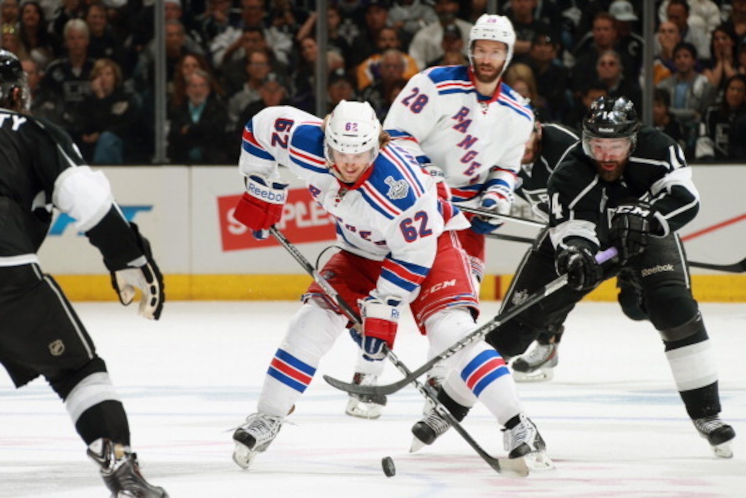 LOS ANGELES, CA - JUNE 13:  Carl Hagelin #62 of the New York Rangers controls the puck away from Justin Williams #14 of the Los Angeles Kings in the third period of Game Five of the 2014 Stanley Cup Final at the Staples Center on June 13, 2014 in Los Ange