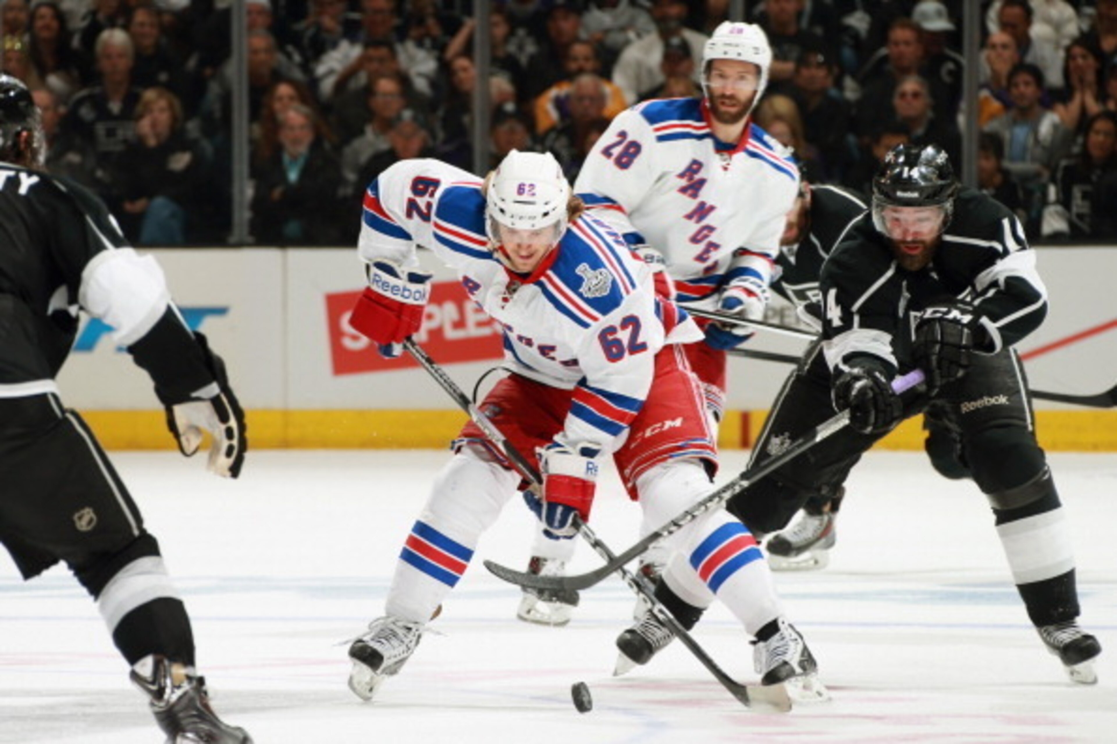 LOS ANGELES, CA - JUNE 13:  Carl Hagelin #62 of the New York Rangers controls the puck away from Justin Williams #14 of the Los Angeles Kings in the third period of Game Five of the 2014 Stanley Cup Final at the Staples Center on June 13, 2014 in Los Ange
