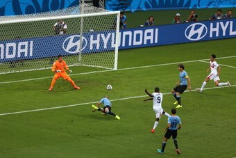 FORTALEZA, BRAZIL - JUNE 14:  Joel Campbell of Costa Rica shoots and scores his team's first goal past Fernando Muslera of Uruguay during the 2014 FIFA World Cup Brazil Group D match between Uruguay and Costa Rica at Castelao on June 14, 2014 in Fortaleza