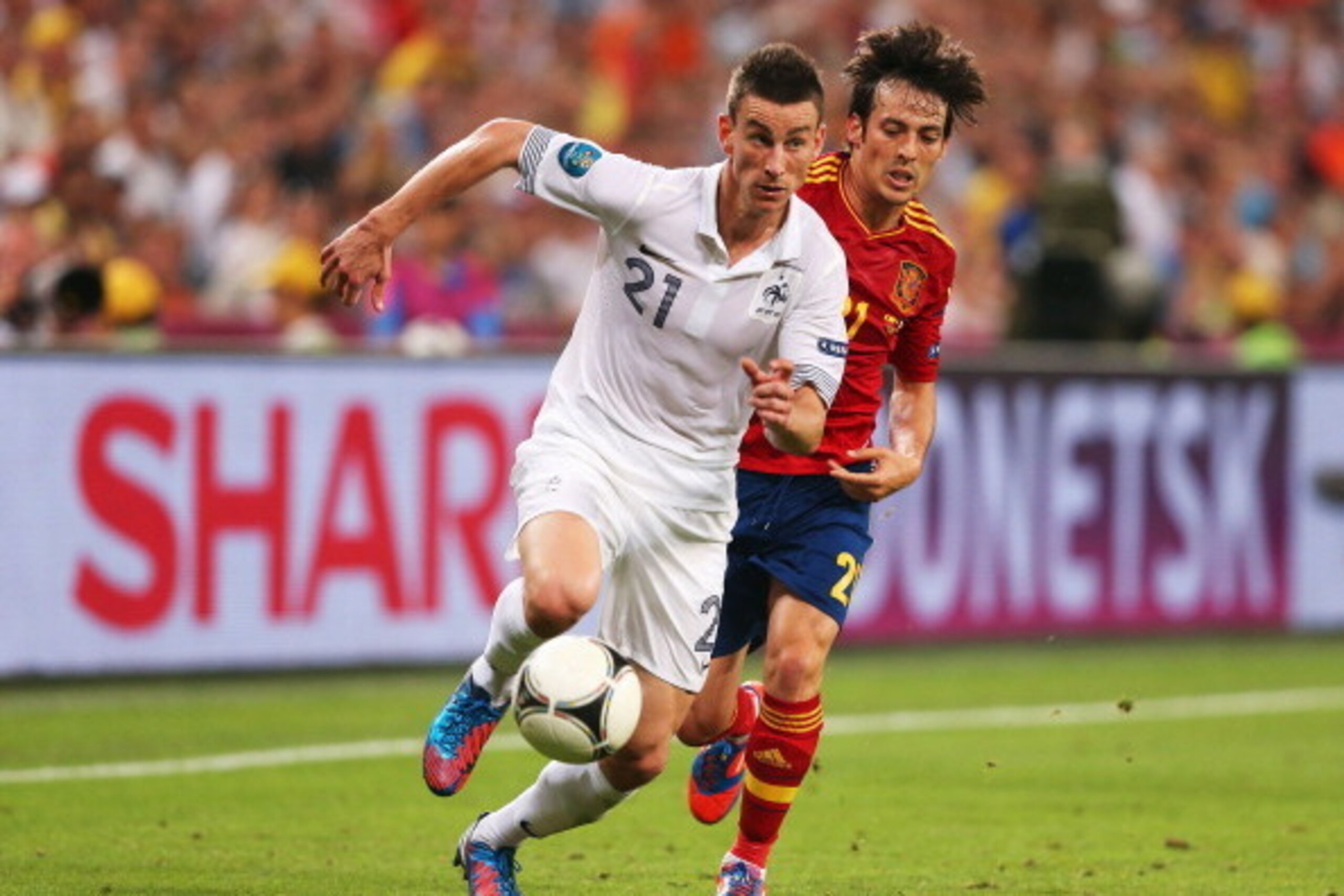 DONETSK, UKRAINE - JUNE 23: Laurent Koscielny of France and David Silva of Spain in action during the UEFA EURO 2012 quarter final match between Spain and France at Donbass Arena on June 23, 2012 in Donetsk, Ukraine.  (Photo by Alex Livesey/Getty Images)