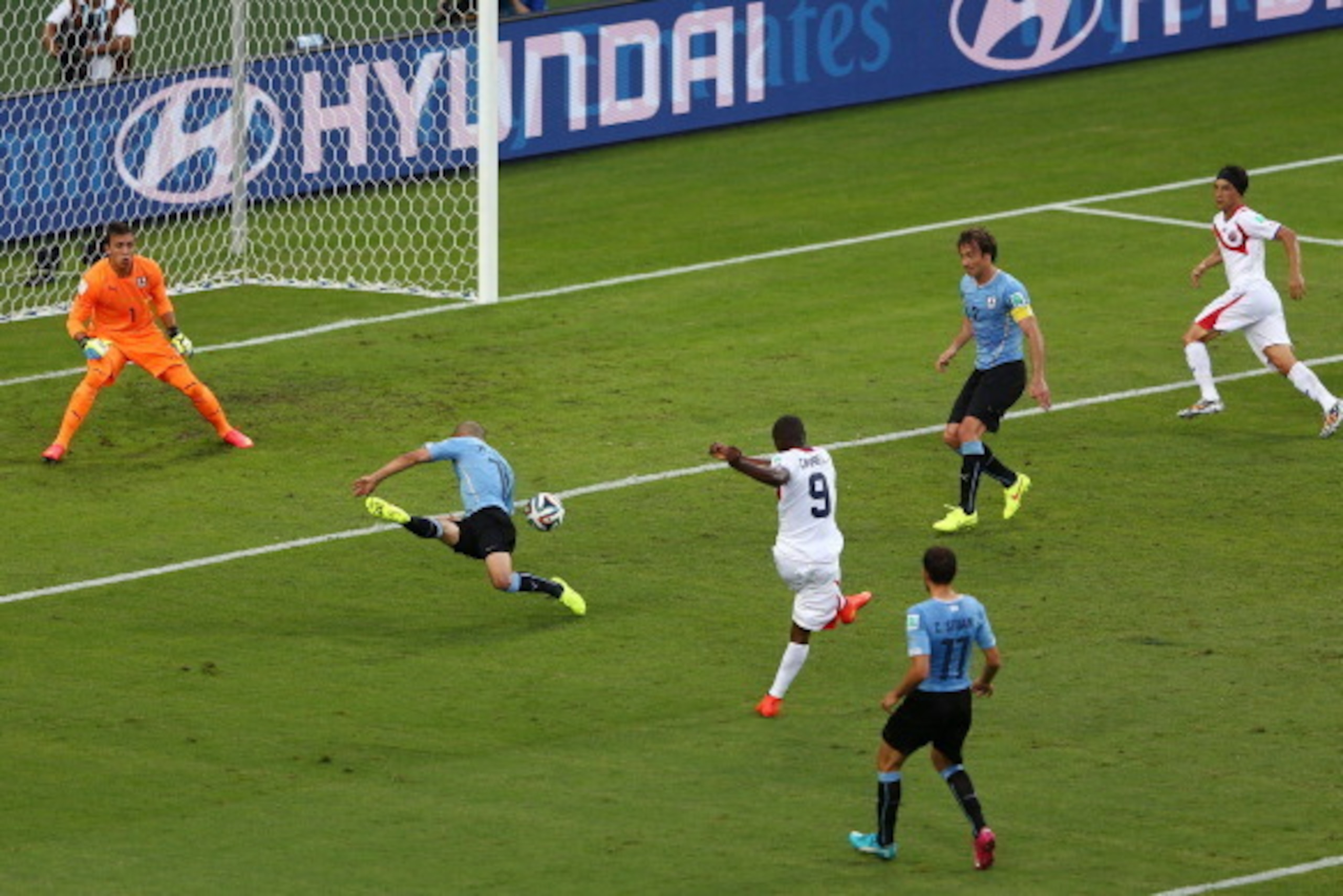 FORTALEZA, BRAZIL - JUNE 14:  Joel Campbell of Costa Rica shoots and scores his team's first goal past Fernando Muslera of Uruguay during the 2014 FIFA World Cup Brazil Group D match between Uruguay and Costa Rica at Castelao on June 14, 2014 in Fortaleza