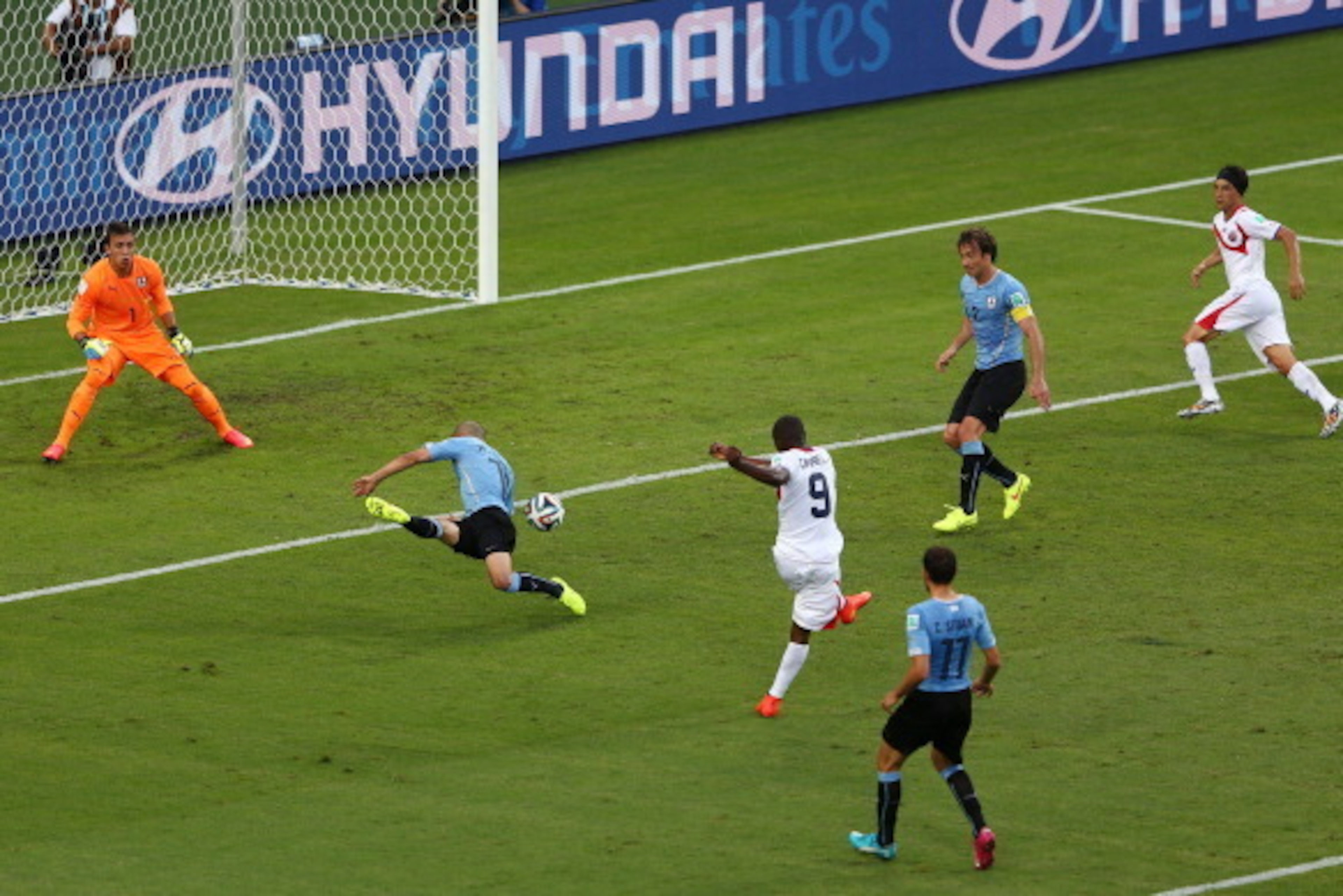 FORTALEZA, BRAZIL - JUNE 14:  Joel Campbell of Costa Rica shoots and scores his team's first goal past Fernando Muslera of Uruguay during the 2014 FIFA World Cup Brazil Group D match between Uruguay and Costa Rica at Castelao on June 14, 2014 in Fortaleza