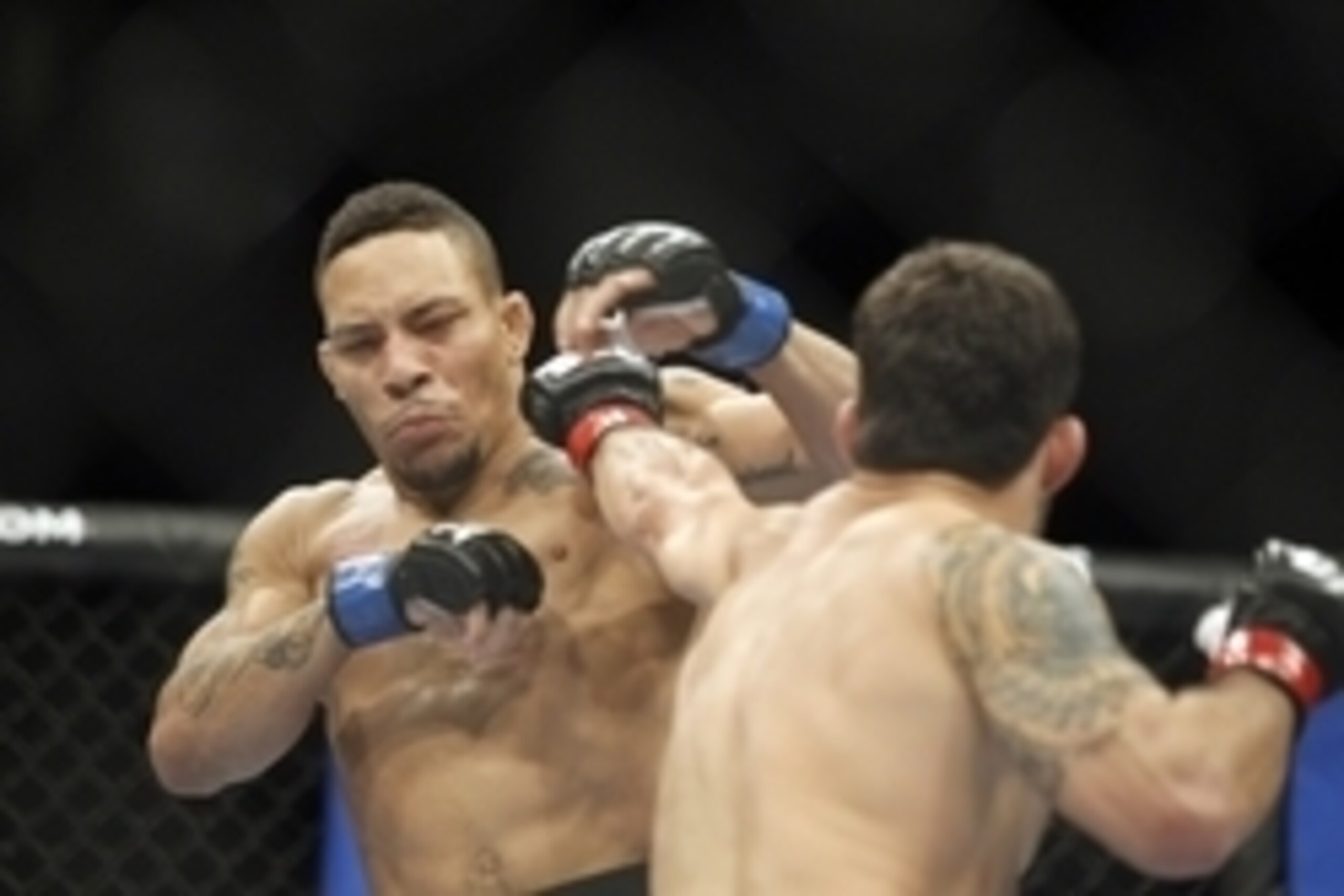 Dec 8, 2012, Seattle, WA, USA; Raphael Assuncao fights Mike Easton, left,  during their third round bantamweight bout at MMA on FOX 5 at Key Arena. Mandatory Credit: Joe Nicholson-USA TODAY Sports
