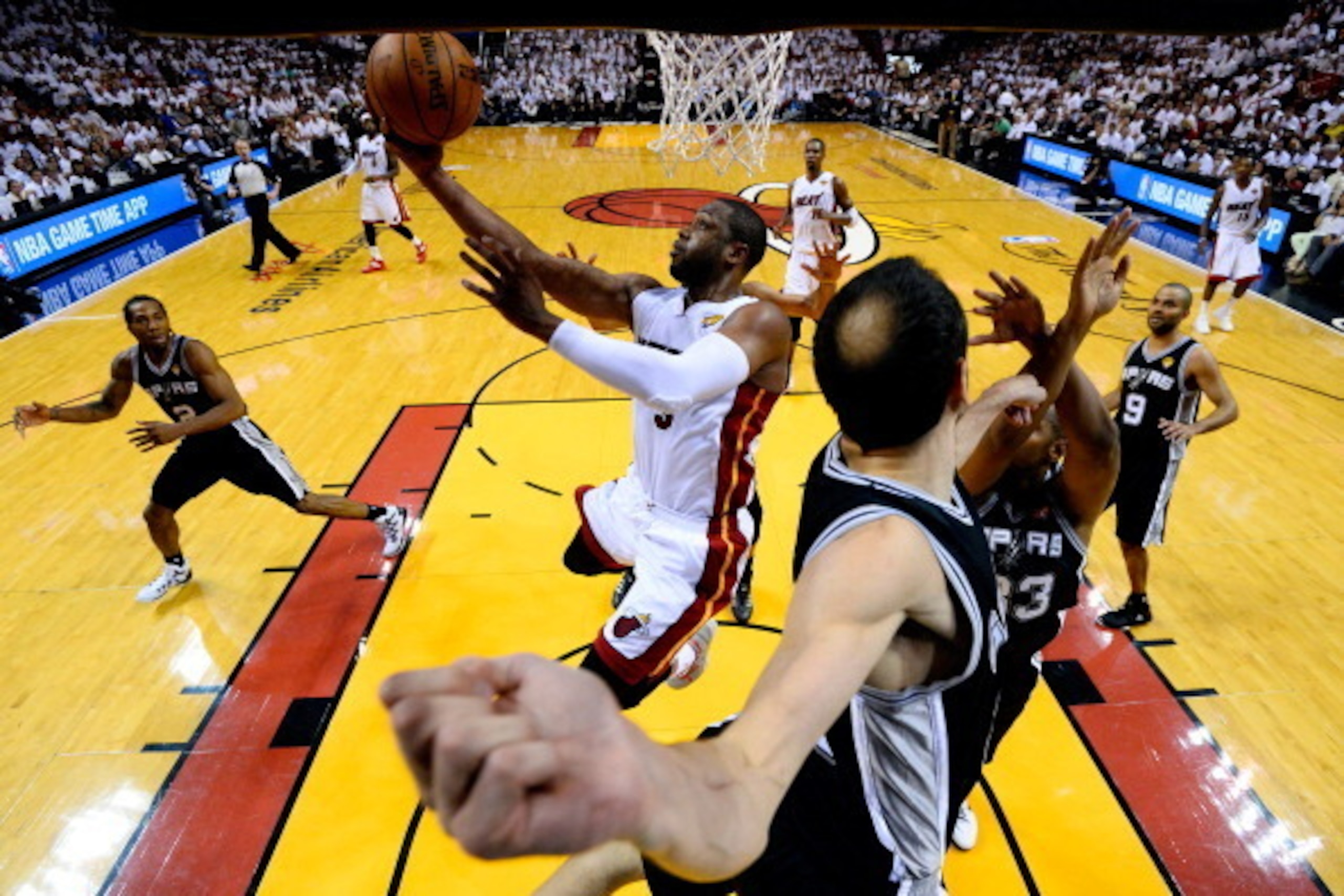 MIAMI, FL - JUNE 12: Dwyane Wade #3 of the Miami Heat goes to the basket against Manu Ginobili #20 of the San Antonio Spurs during Game Four of the 2014 NBA Finals at American Airlines Arena on June 12, 2014 in Miami, Florida. NOTE TO USER: User expressly
