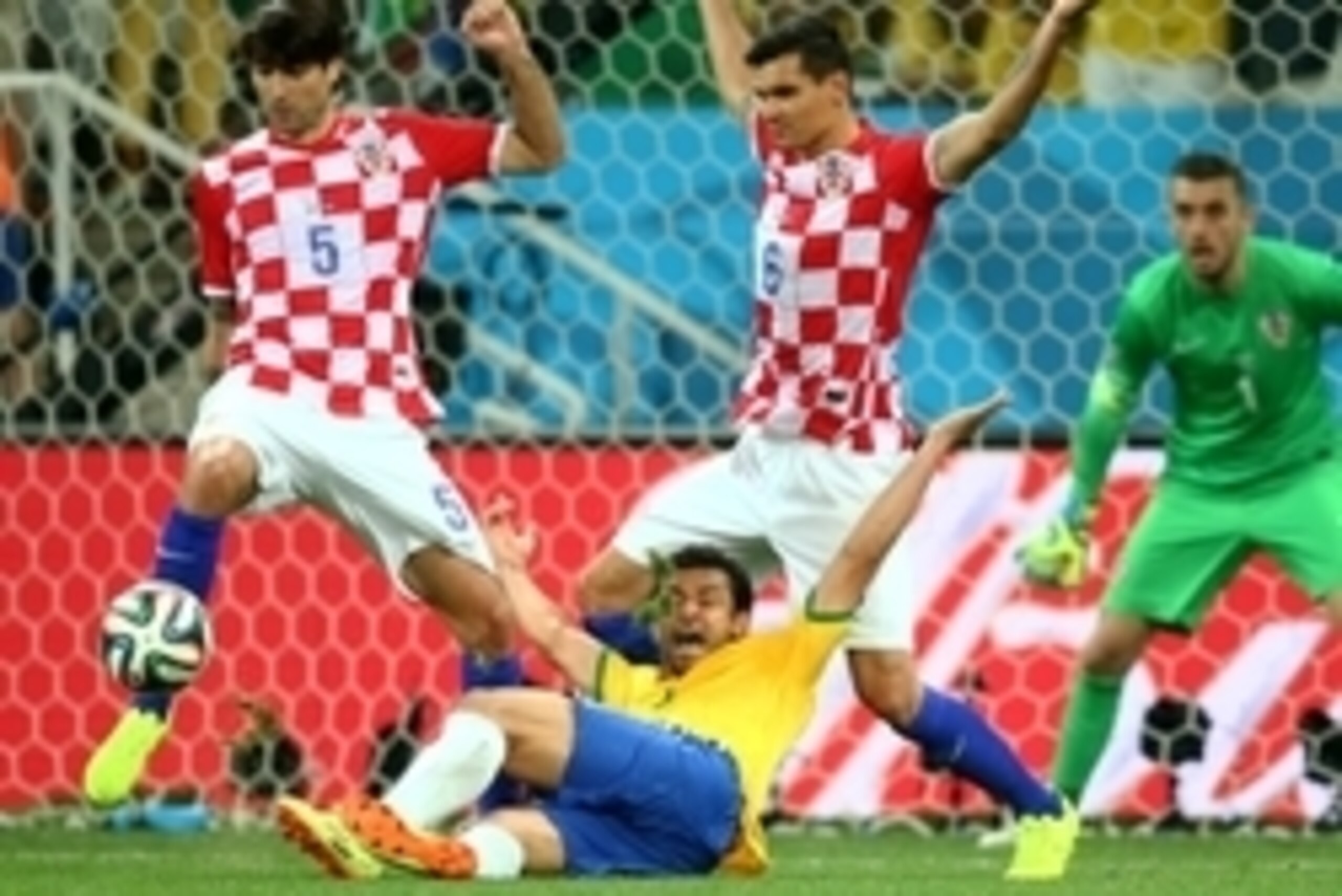 Jun 12, 2014; Sao Paulo, BRAZIL; Brazil forward Fred (9) falls to the ground as he reacts after being touched by Croatia defender Dejan Lovren (6) in the second half during the opening game of the 2014 World Cup at Arena Corinthians. Brazil would be award