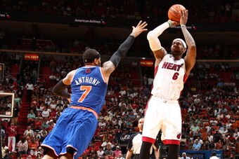 MIAMI, FL - APRIL 6: LeBron James #6 of the Miami Heat shoots over Carmelo Anthony #7 of the New York Knicks during a game on April 6, 2014 at American Airlines Arena in Miami, Florida.  NOTE TO USER: User expressly acknowledges and agrees that, by downlo