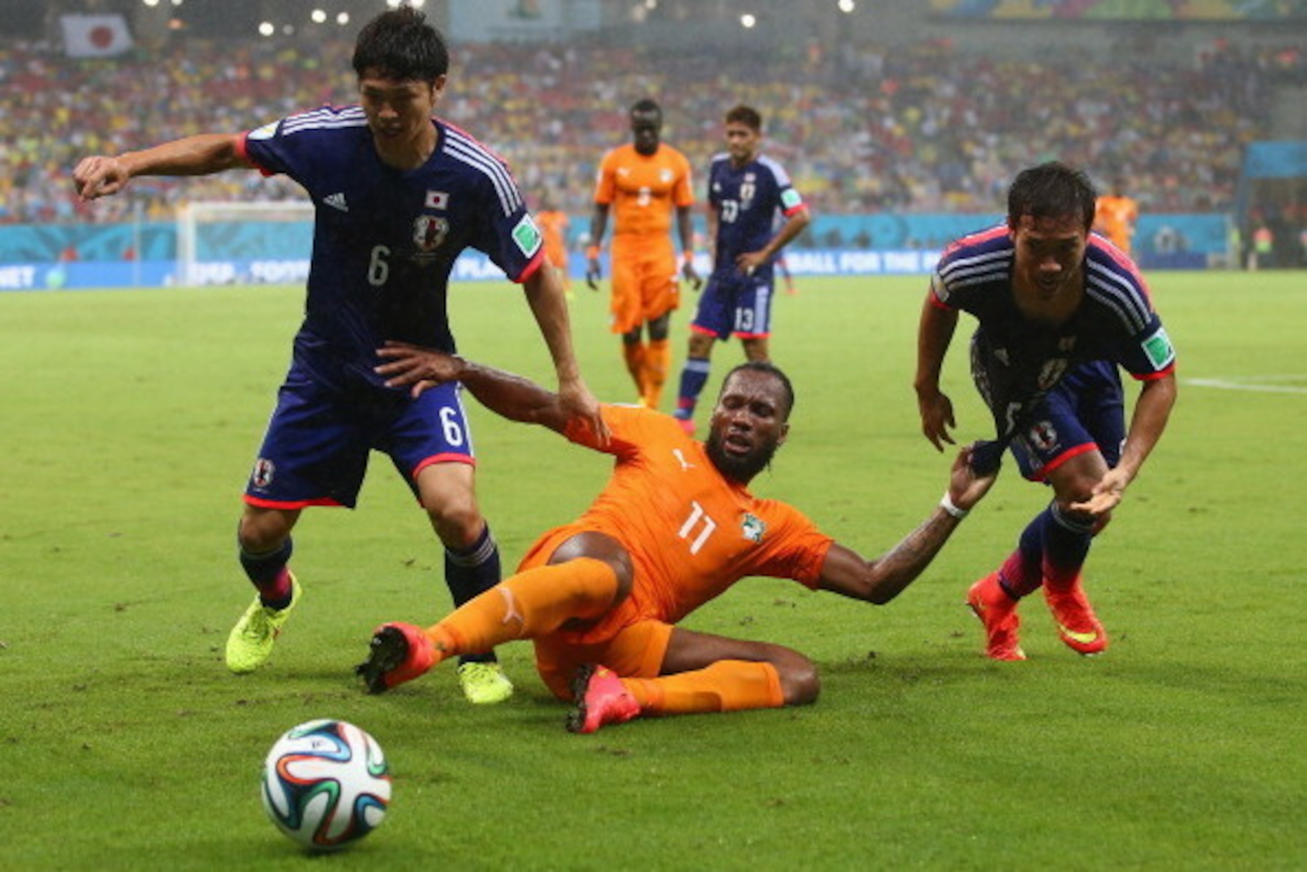 RECIFE, BRAZIL - JUNE 14:  Masato Morishige (L) and Yuto Nagatomo of Japan challenge Didier Drogba of the Ivory Coast during the 2014 FIFA World Cup Brazil Group C match  between the Ivory Coast and Japan at Arena Pernambuco on June 14, 2014 in Recife, Br