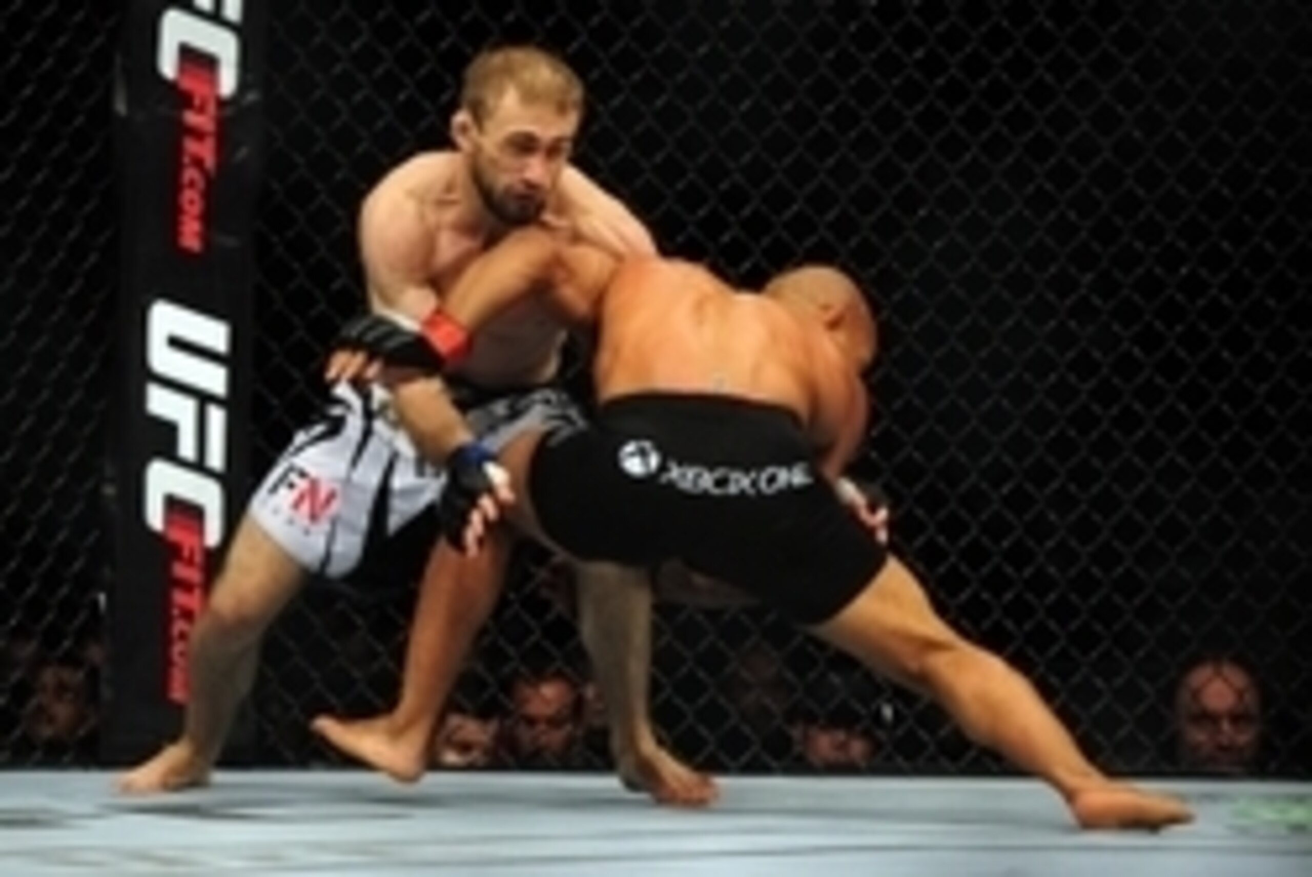 Jun 14, 2014; Vancouver, British Columbia, Canada; Demetrious Johnson (red) fights against Ali Bagautinov (blue) in the Flyweight Title bout at UFC 174 at Rogers Arena. Mandatory Credit: Anne-Marie Sorvin-USA TODAY Sports