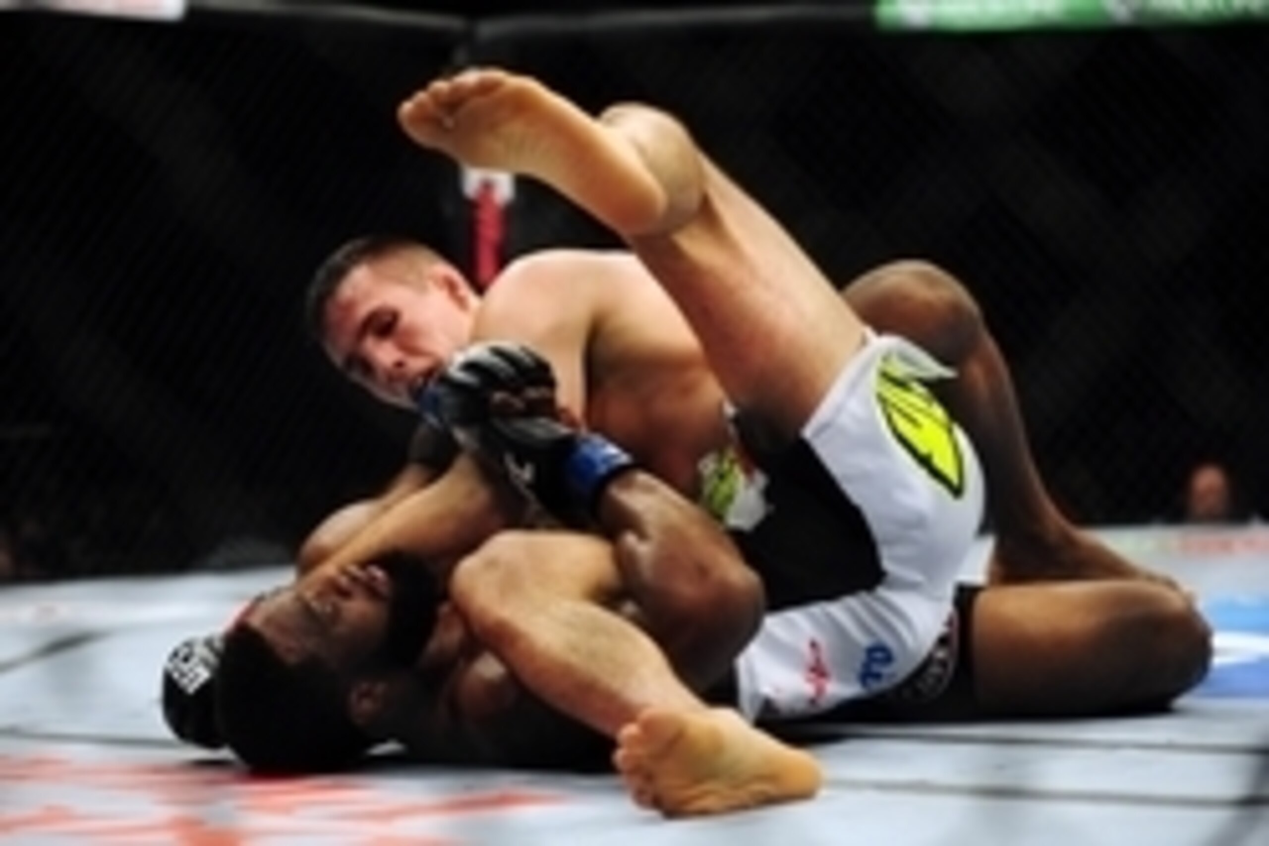 Jun 14, 2014; Vancouver, British Columbia, Canada; Rory MacDonald (red) fights against Tyron Woodley (blue) in their welterweight bout at UFC 174 at Rogers Arena. Mandatory Credit: Anne-Marie Sorvin-USA TODAY Sports
