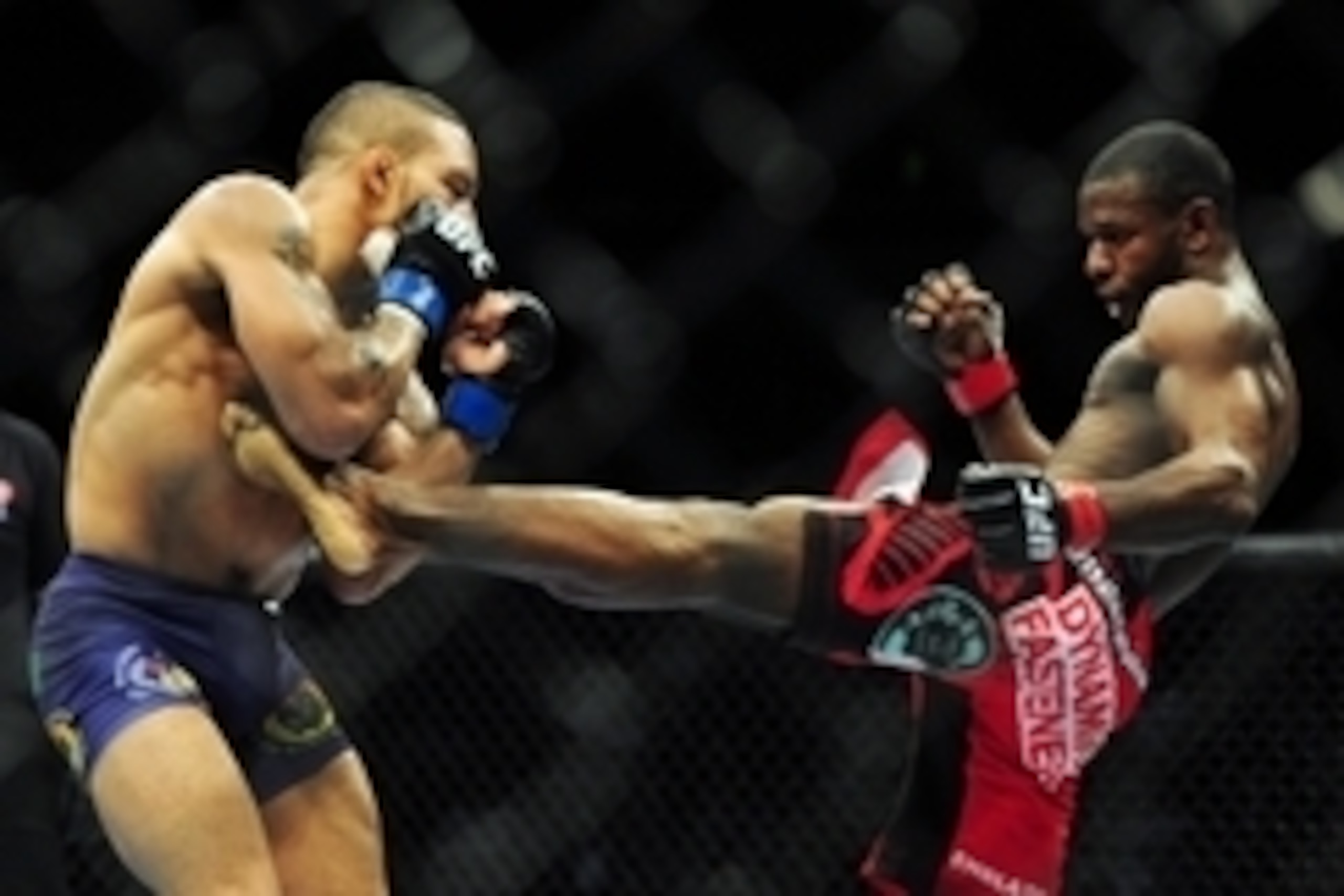 Jun 14, 2014; Vancouver, British Columbia, Canada; Yves Jabouin (red) fights against Mike Easton (blue) in their Bantamweight bout during UFC 174 at Rogers Arena. Mandatory Credit: Anne-Marie Sorvin-USA TODAY Sports