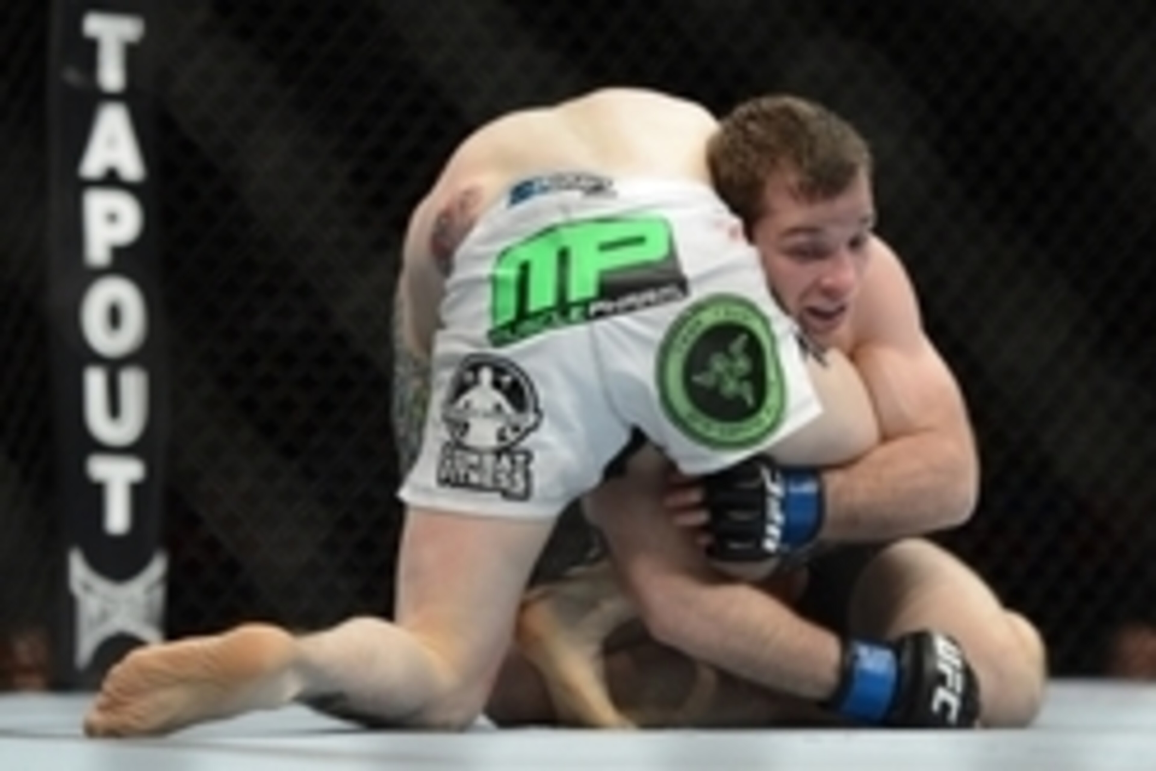 December 14, 2013; Sacramento, CA, USA; Scott Jorgensen (red gloves) fights Zach Makovsky (blue gloves) during the flyweight bout of the UFC on FOX 9 at Sleep Train Arena. Mandatory Credit: Kyle Terada-USA TODAY Sports