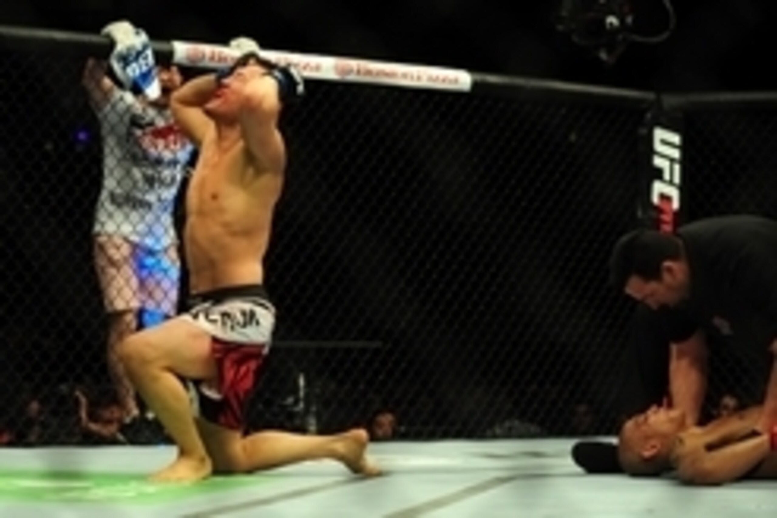 Jun 14, 2014; Vancouver, British Columbia, Canada; fights Tae Hyun Bang (blue) defeats Kajan Johnson (red) in the third round of their Lightweight bout during UFC 174 at Rogers Arena. Mandatory Credit: Anne-Marie Sorvin-USA TODAY Sports