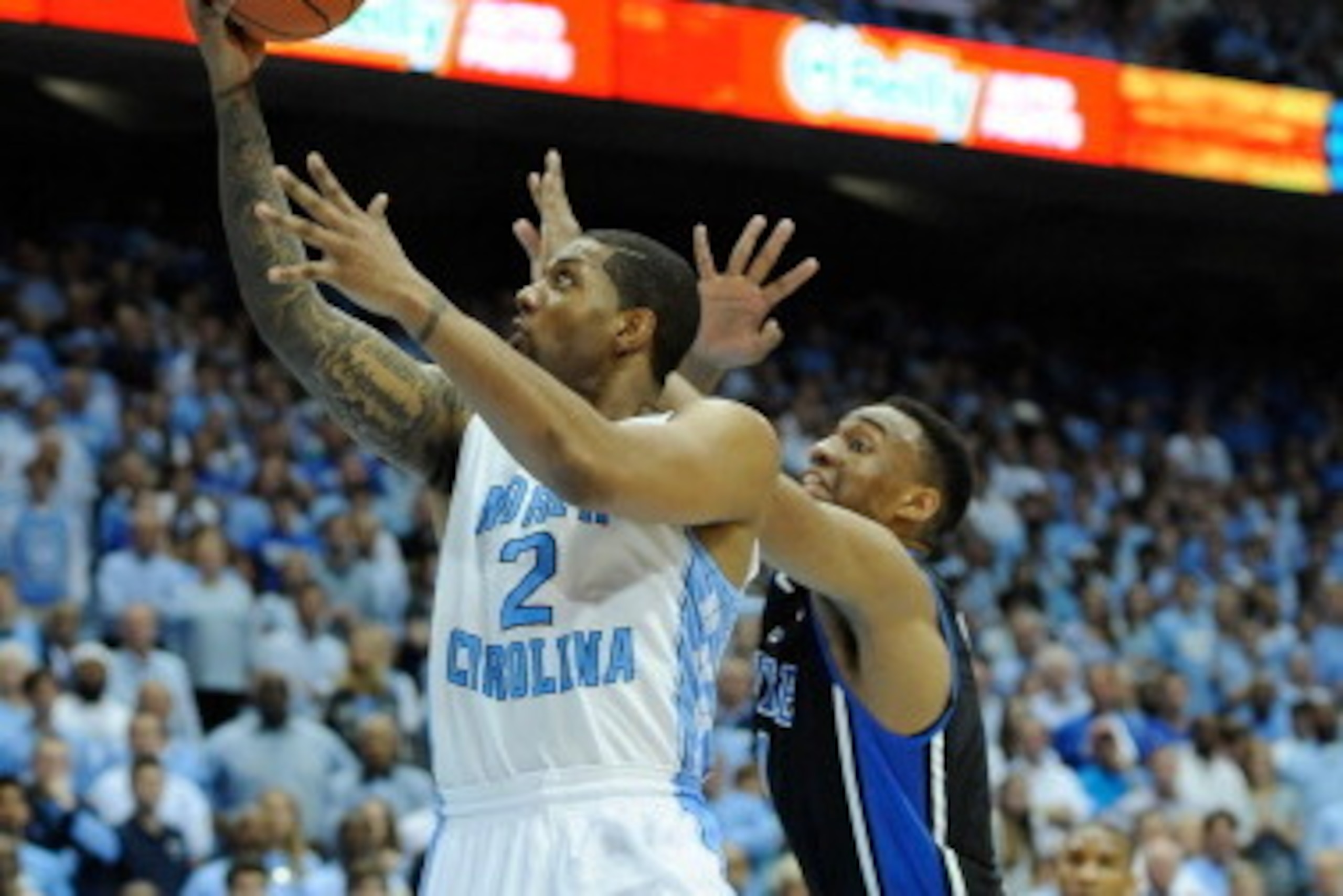 CHAPEL HILL, NC - FEBRUARY 20: Jabari Parker #1 of the Duke Blue Devils defends a shot by Leslie McDonald #2 of the North Carolina Tar Heels during their game at the Dean Smith Center on February 20, 2014 in Chapel Hill, North Carolina. North Carolina wo CHAPEL HILL, NC - FEBRUARY 20: Jabari Parker #1 of the Duke Blue Devils defends a shot by Leslie McDonald #2 of the North Carolina Tar Heels during their game at the Dean Smith Center on February 20, 2014 in Chapel Hill, North Carolina. North Carolina wo