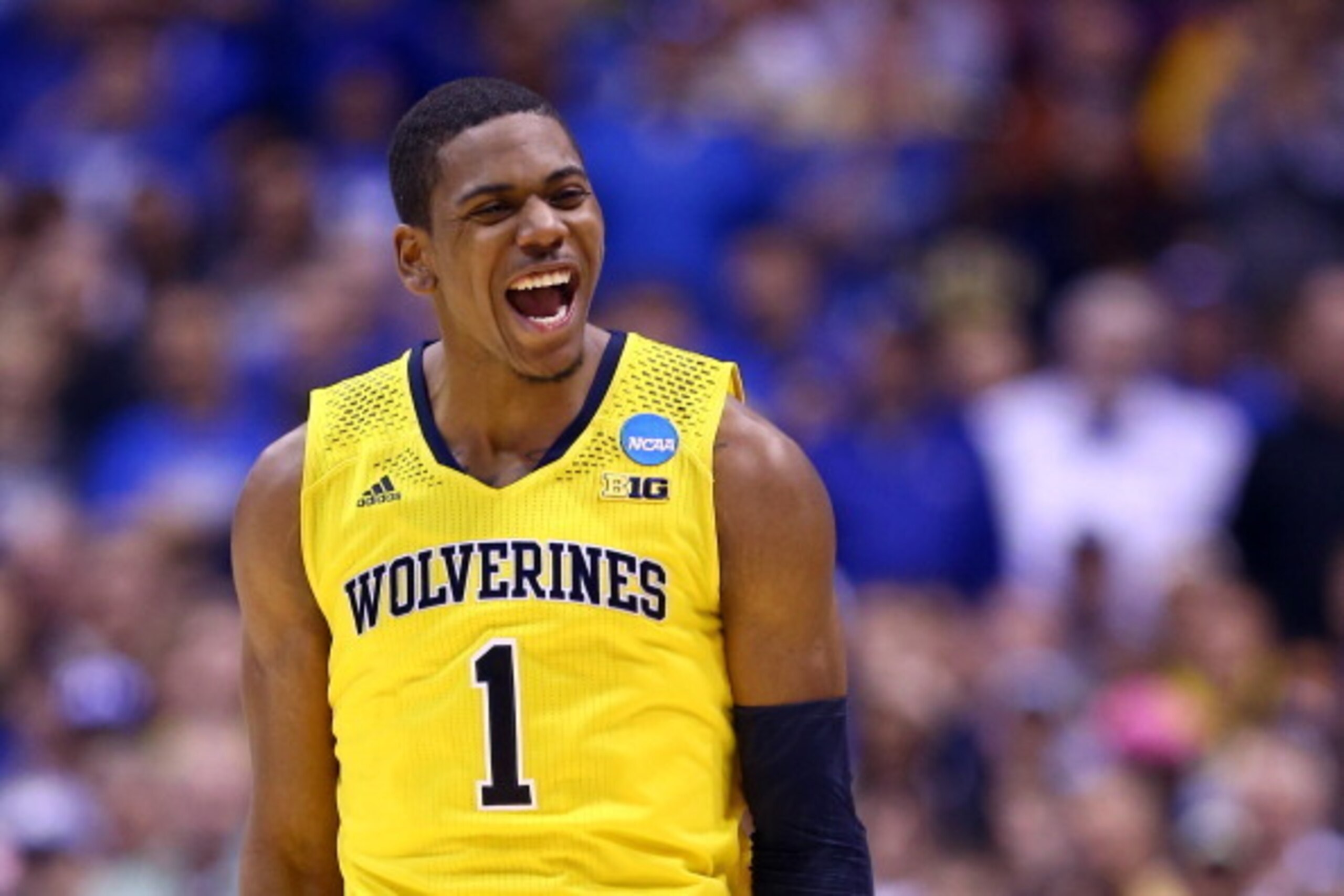 INDIANAPOLIS, IN - MARCH 30:  Glenn Robinson III #1 of the Michigan Wolverines celebrates after a basket in the second half against the Kentucky Wildcats during the midwest regional final of the 2014 NCAA Men's Basketball Tournament at Lucas Oil Stadium o