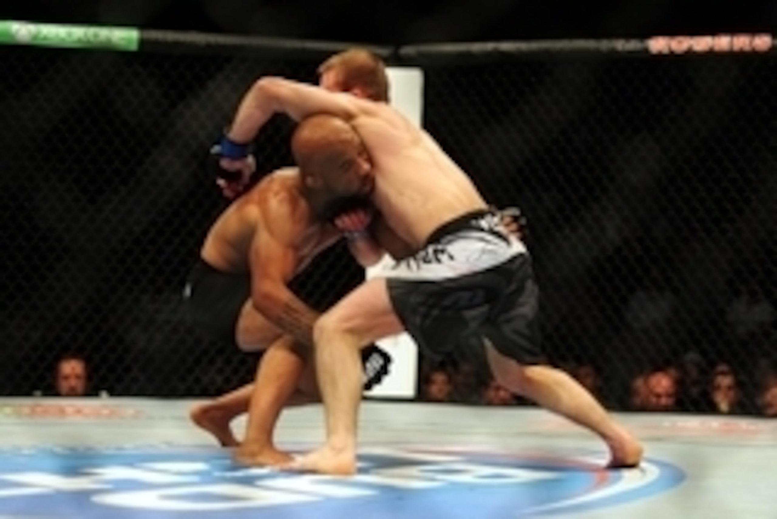 Jun 14, 2014; Vancouver, British Columbia, Canada; Demetrious Johnson (red) fights against Ali Bagautinov (blue) in the flyweight title bout at UFC 174 at Rogers Arena. Mandatory Credit: Anne-Marie Sorvin-USA TODAY Sports