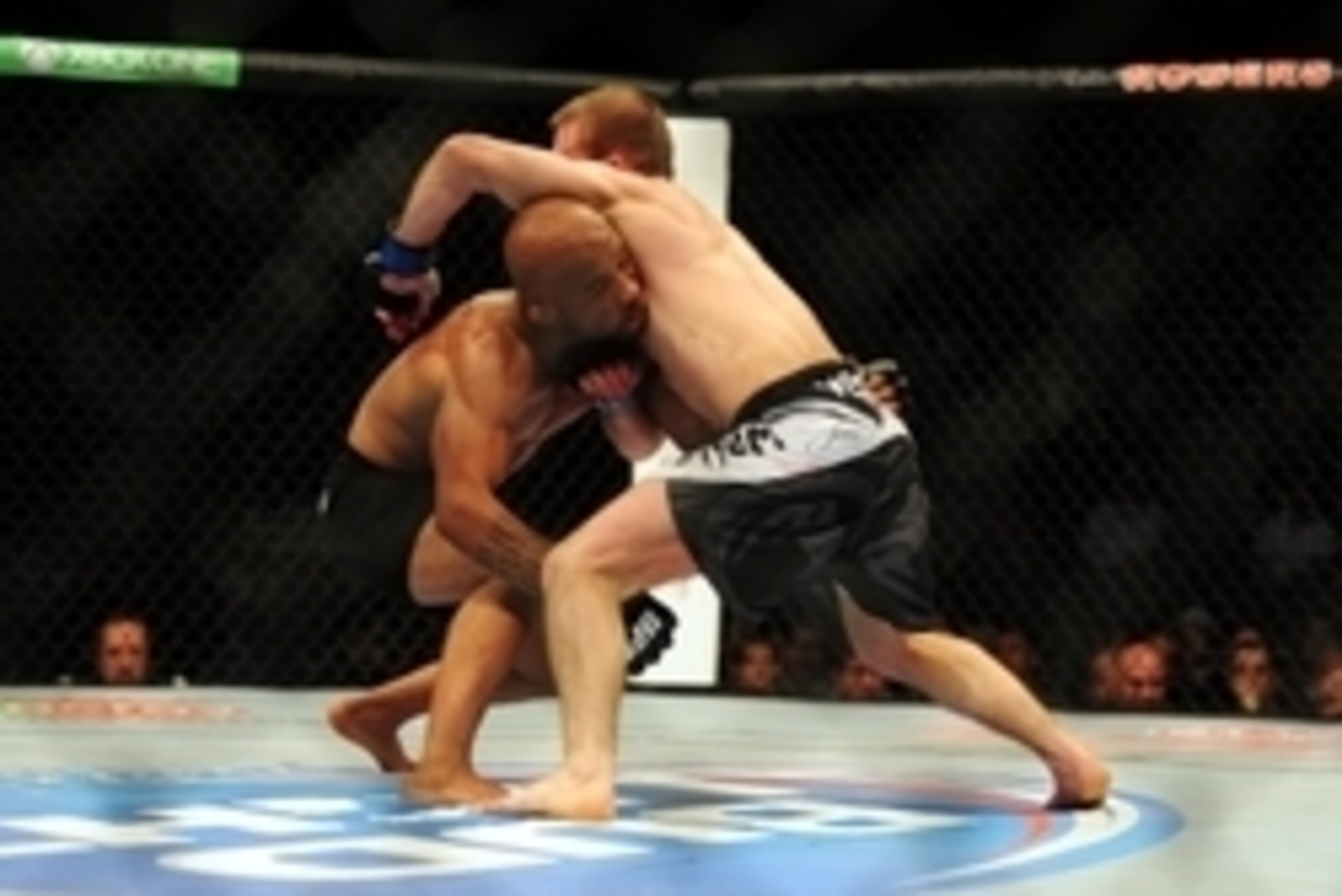 Jun 14, 2014; Vancouver, British Columbia, Canada; Demetrious Johnson (red) fights against Ali Bagautinov (blue) in the flyweight title bout at UFC 174 at Rogers Arena. Mandatory Credit: Anne-Marie Sorvin-USA TODAY Sports