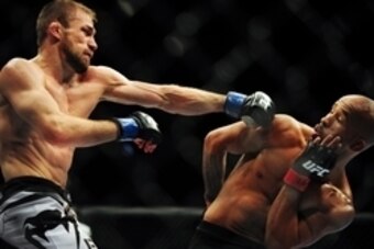Jun 14, 2014; Vancouver, British Columbia, Canada; Demetrious Johnson (red) fights against Ali Bagautinov (blue) in the flyweight title bout at UFC 174 at Rogers Arena. Mandatory Credit: Anne-Marie Sorvin-USA TODAY Sports