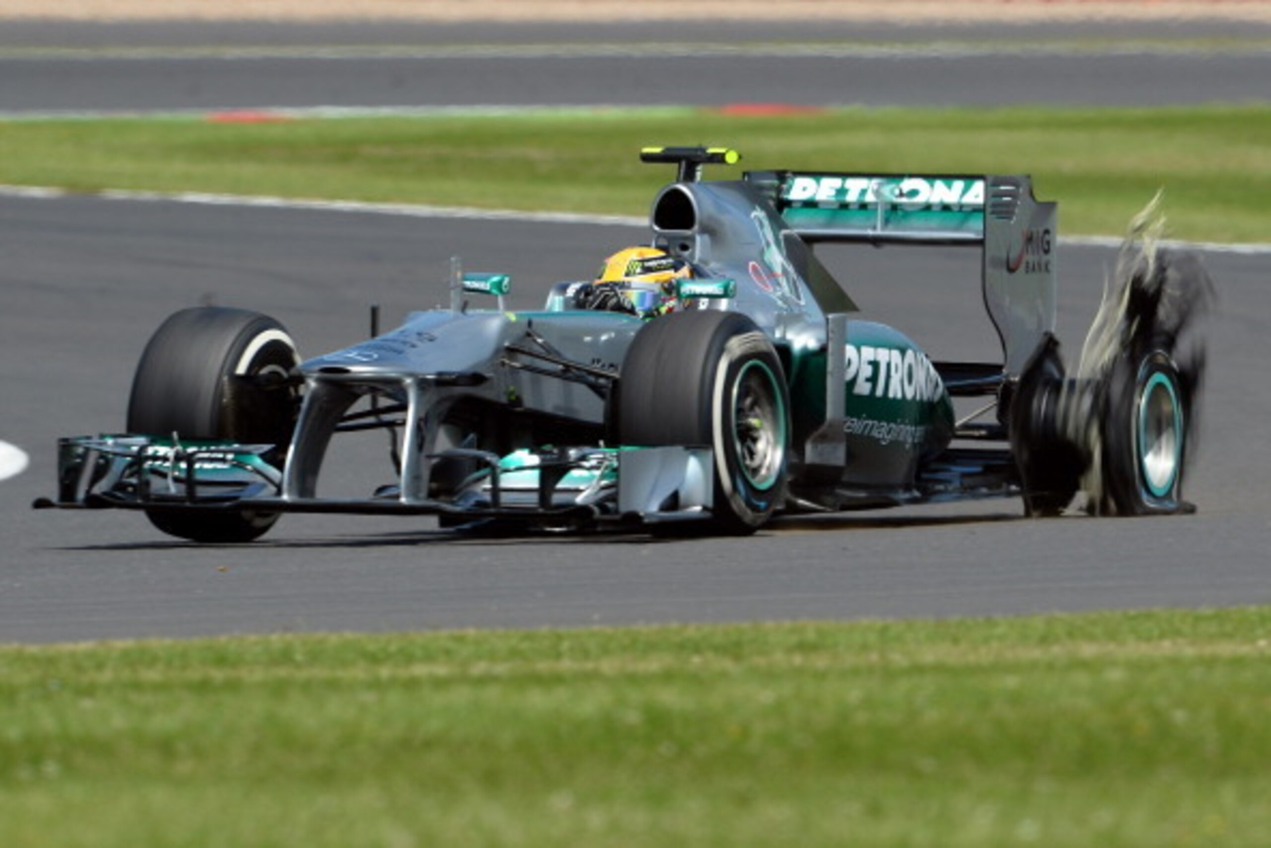 NORTHAMPTON, ENGLAND - JUNE 30:  Lewis Hamilton of Great Britain and Mercedes GP has a left rear tyre failure during the British Formula One Grand Prix at Silverstone Circuit on June 30, 2013 in Northampton, England.  (Photo by Lars Baron/Getty Images)