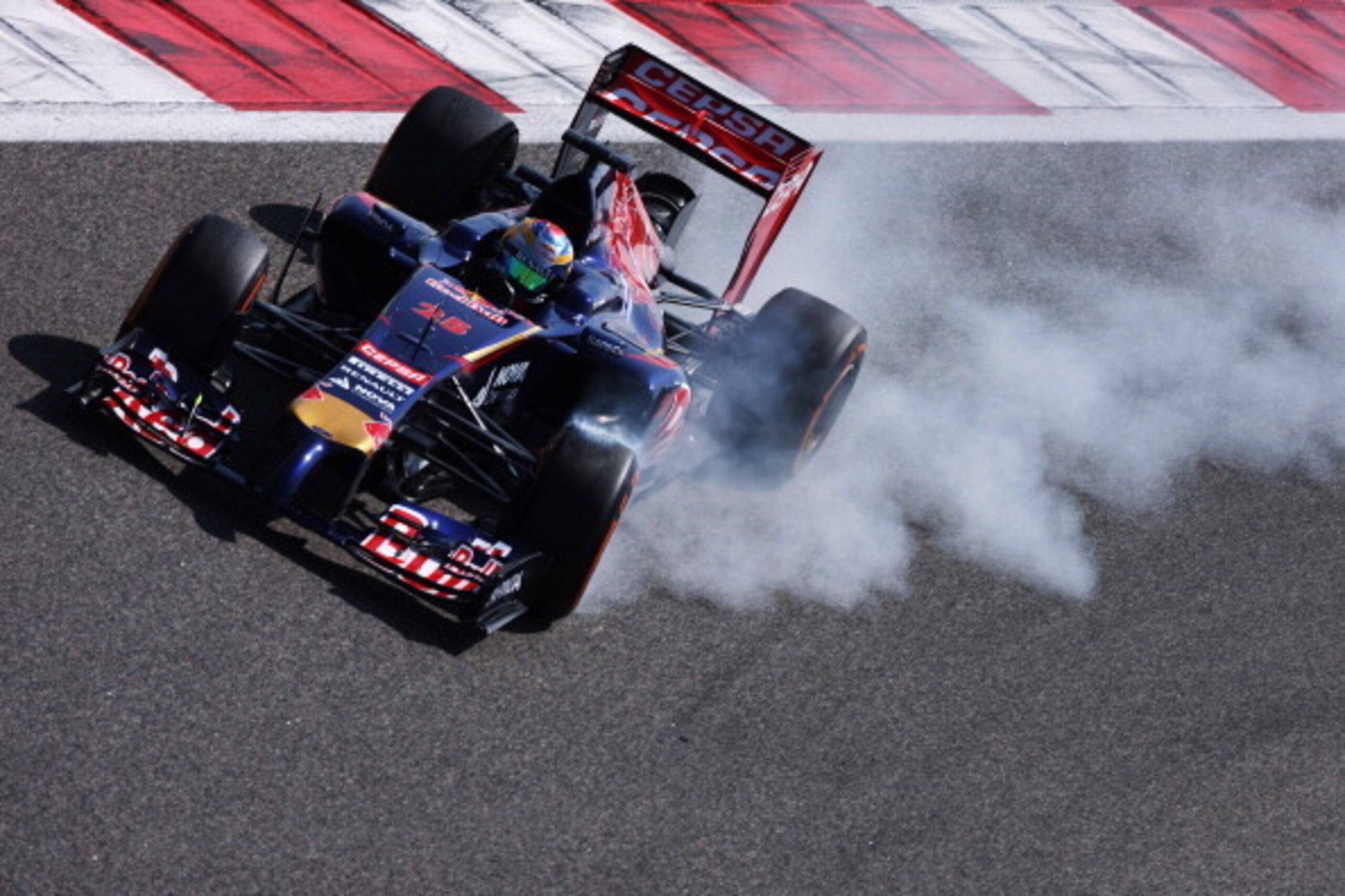 BAHRAIN, BAHRAIN - FEBRUARY 20:  Jean-Eric Vergne of France and Scuderia Toro Rosso locks up as he drives during day two of Formula One Winter Testing at the Bahrain International Circuit on February 20, 2014 in Bahrain, Bahrain.  (Photo by Ker Robertson/