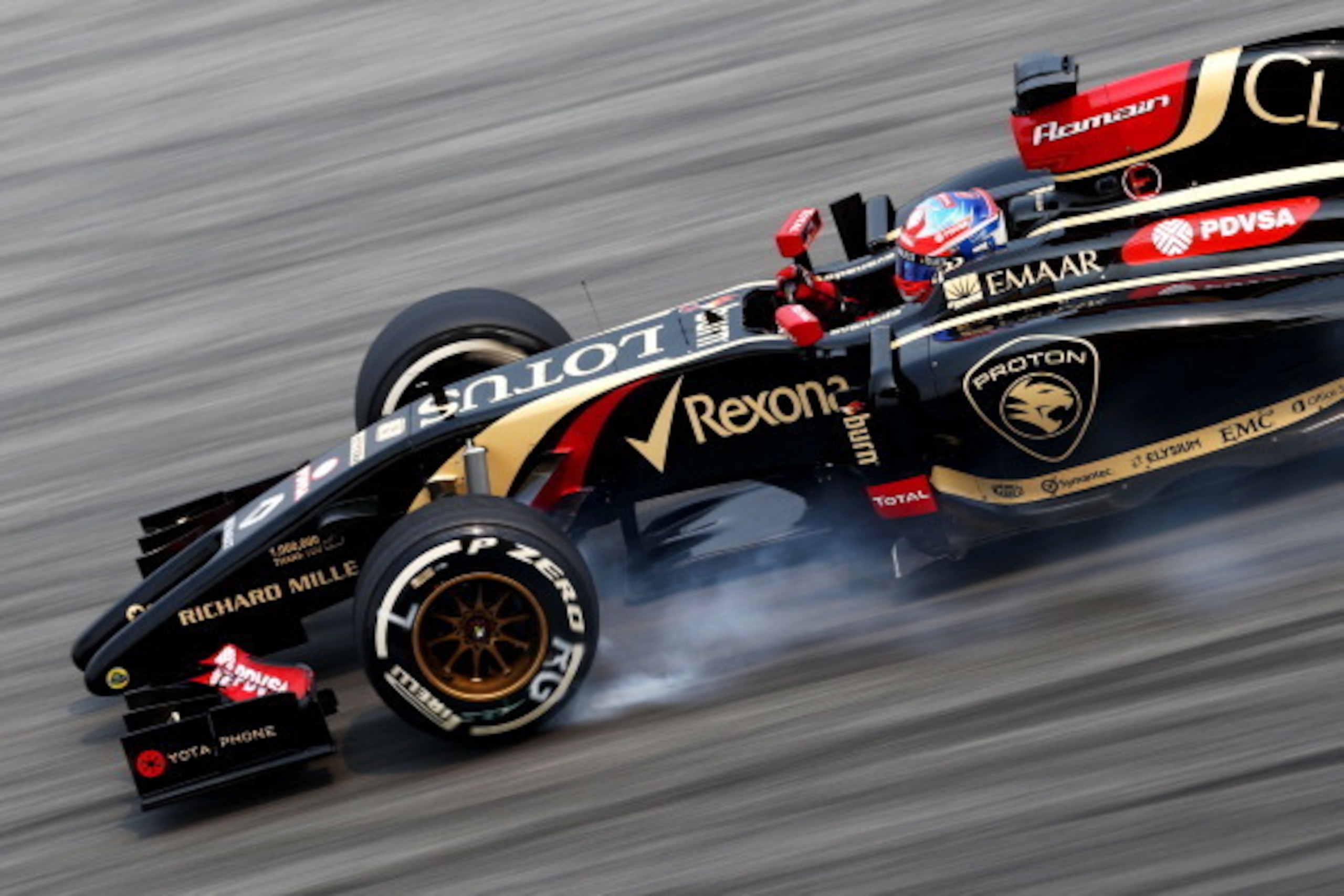 KUALA LUMPUR, MALAYSIA - MARCH 28:  Romain Grosjean of France and Lotus locks up during practice for the Malaysia Formula One Grand Prix at the Sepang Circuit on March 28, 2014 in Kuala Lumpur, Malaysia.  (Photo by Paul Gilham/Getty Images)