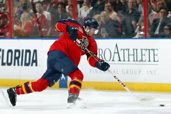 SUNRISE, FL - FEBRUARY 27:  Jonathan Huberdeau #11 of the Florida Panthers passes the puck against the Washington Capitals at the BB&T Center on February 27, 2014 in Sunrise, Florida. (Photo by Eliot J. Schechter/NHLI via Getty Images)