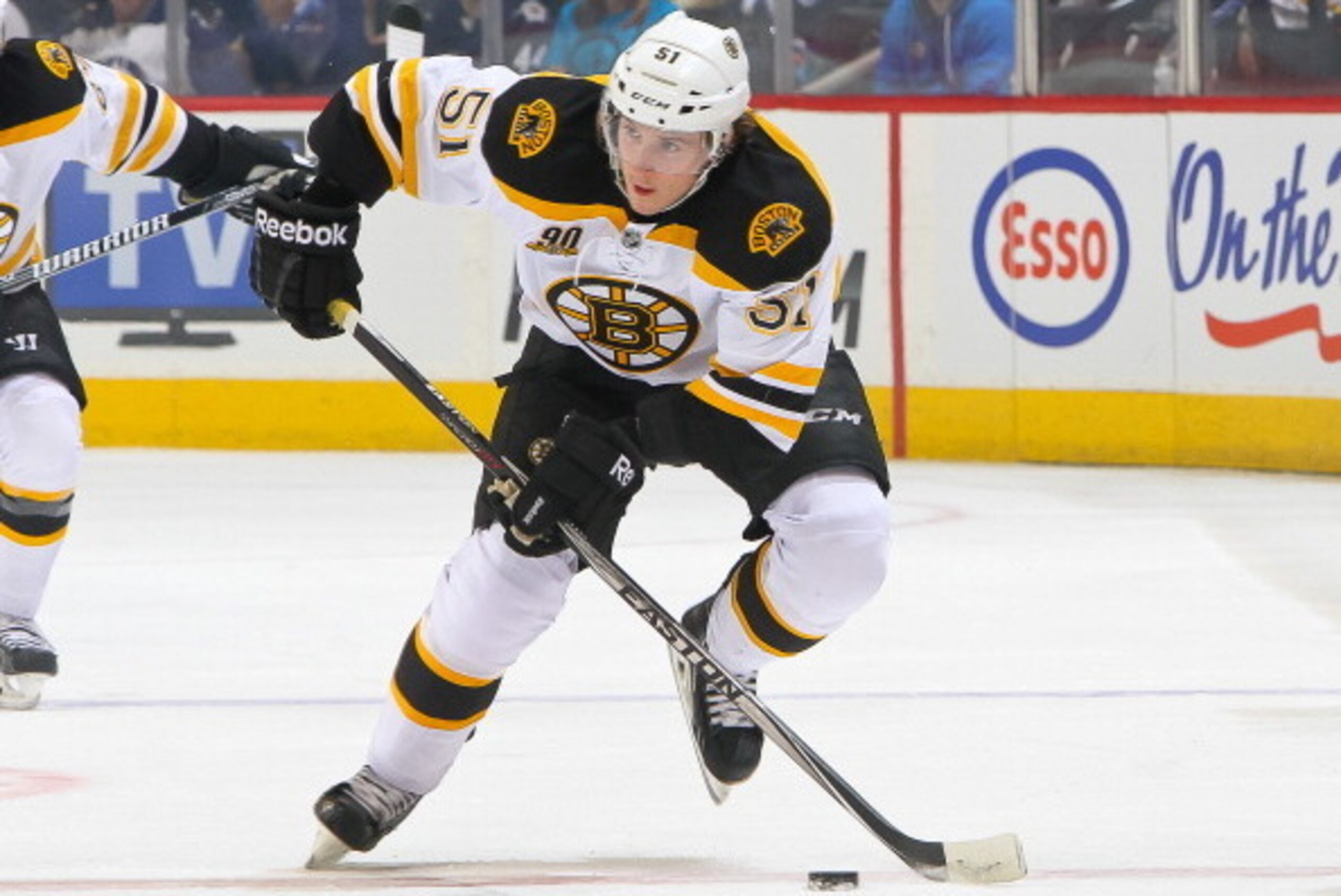 WINNIPEG, MB - APRIL 10: Ryan Spooner #51 of the Boston Bruins plays the puck up the ice during first period action against the Winnipeg Jets at the MTS Centre on April 10, 2014 in Winnipeg, Manitoba, Canada. The Jets defeated the Bruins 2-1 in the shooto