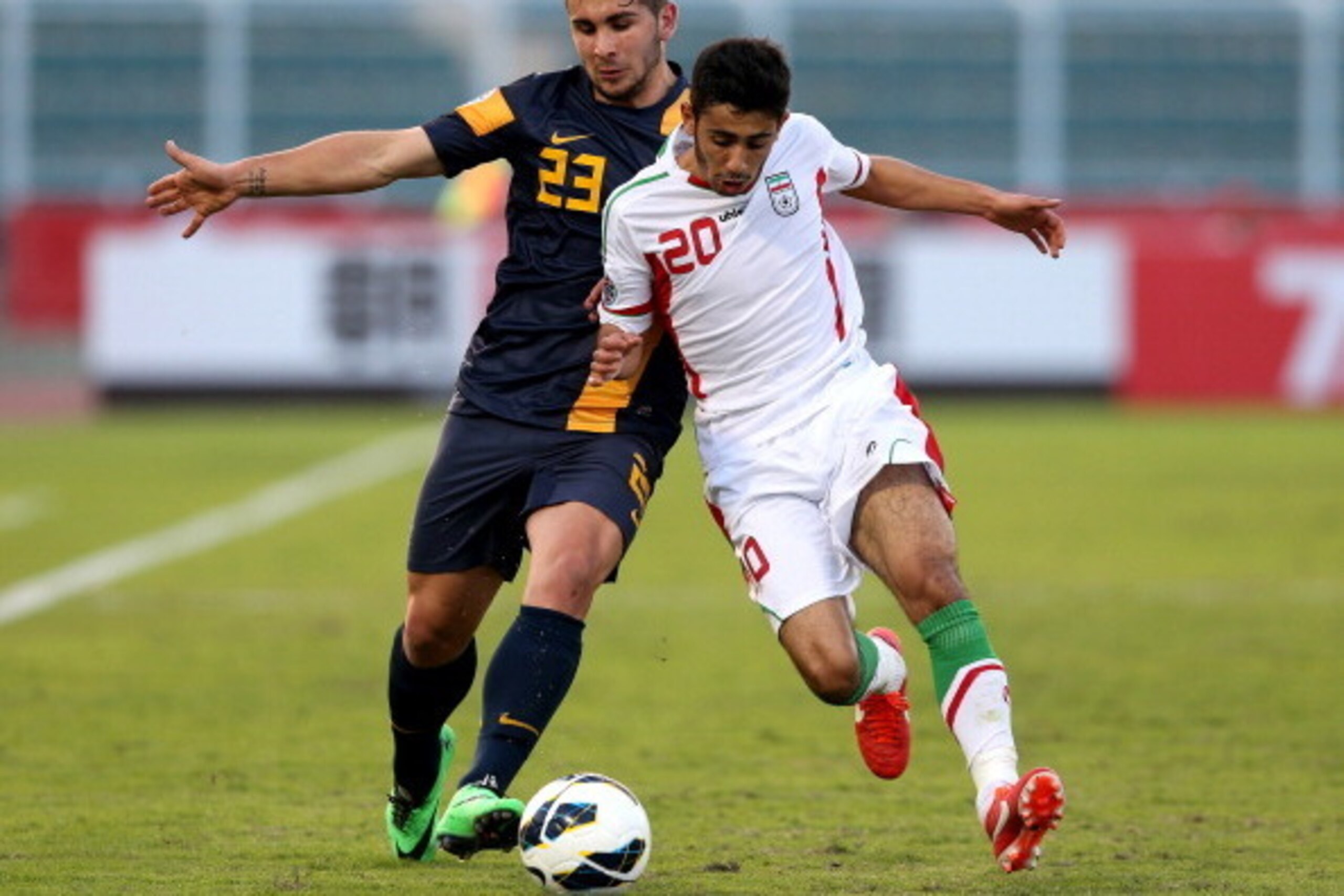MUSCAT, OMAN - JANUARY 14:  Petros Skapetis (L) of Australia competes for the ball with Eshan Pahlavan of Iran during the AFC U-22 Championship Group C match between Iran and Australia at Royal Oman Police Stadium on January 14, 2014 in Muscat, Oman.  (Ph
