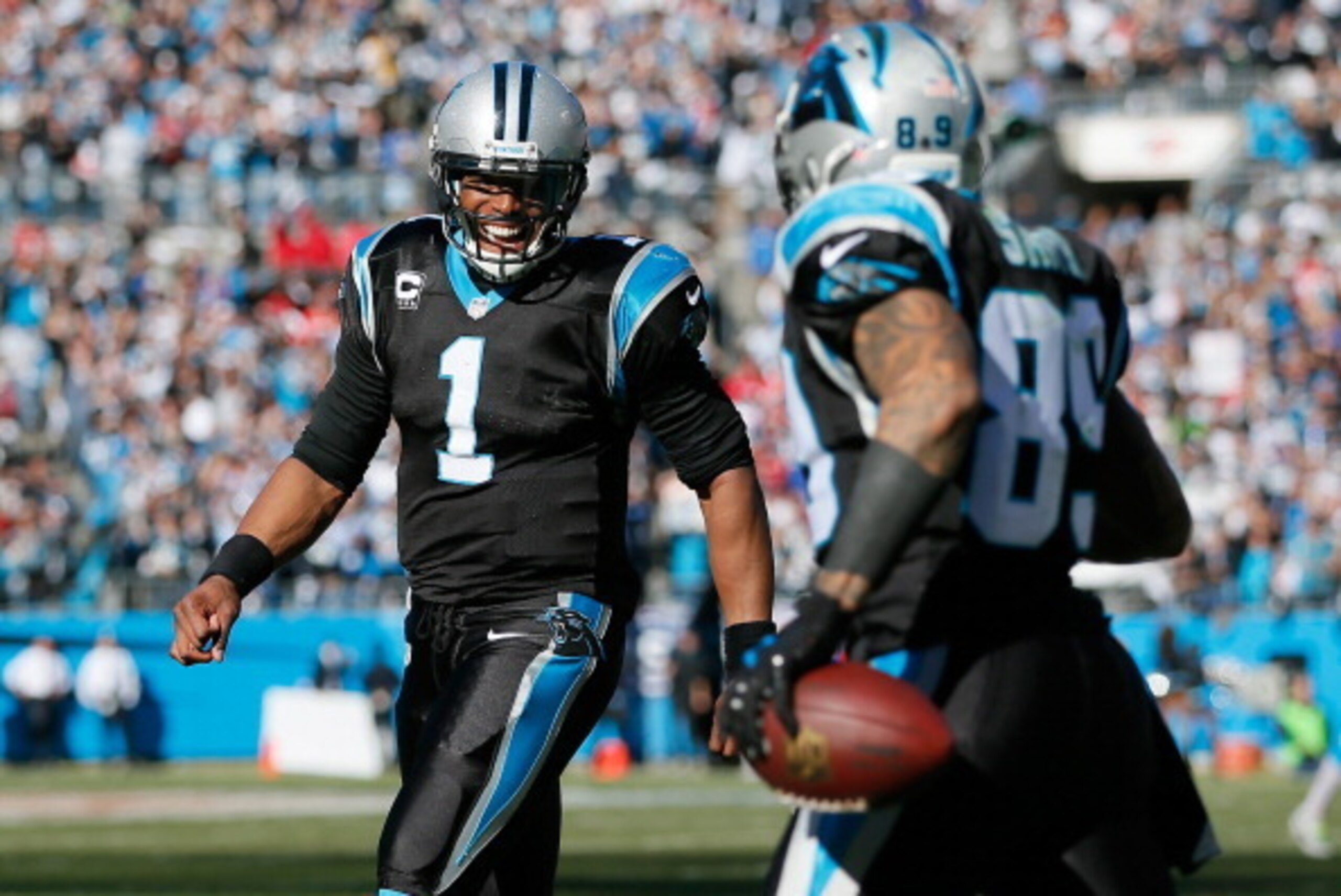CHARLOTTE, NC - JANUARY 12:  Cam Newton #1 of the Carolina Panthers celebrates with Steve Smith #89 after a touchdown in the second quarter against the San Francisco 49ers during the NFC Divisional Playoff Game at Bank of America Stadium on January 12, 20